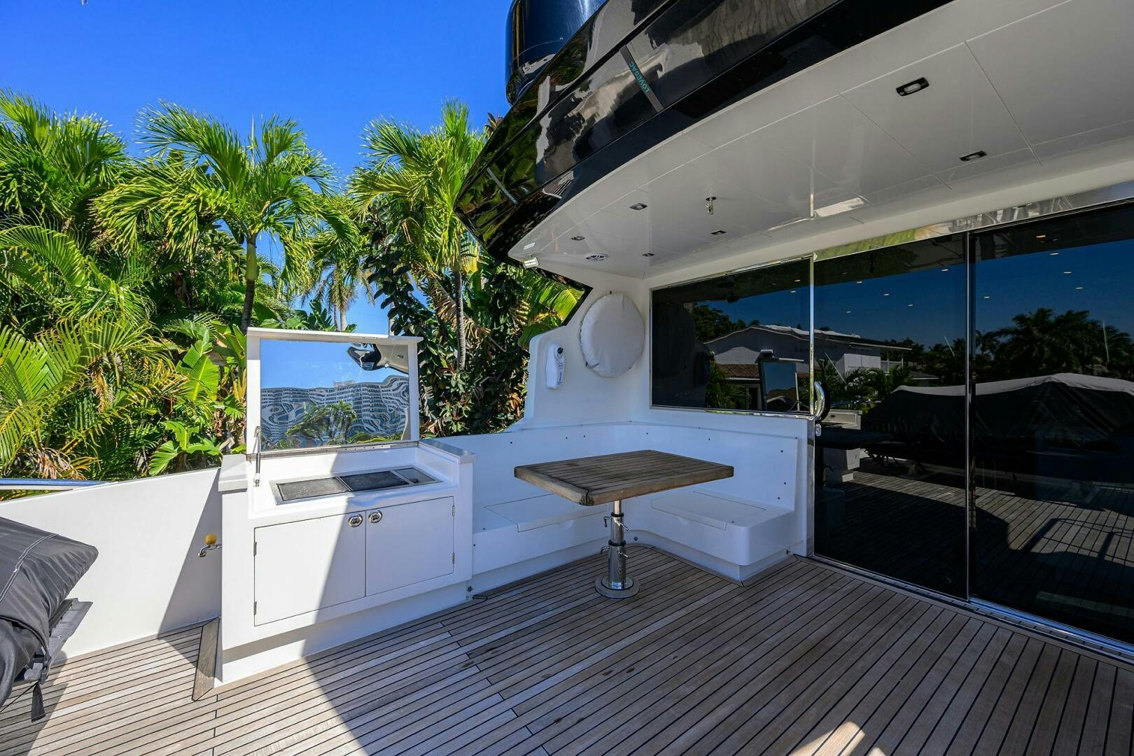 a room with a table and a tv on the wall aboard FUJIMO Yacht for Sale
