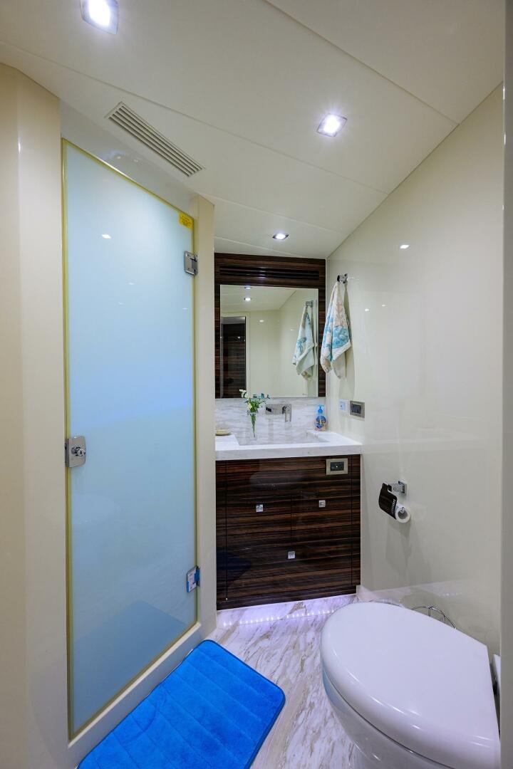 a bathroom with a blue shower door aboard FUJIMO Yacht for Sale