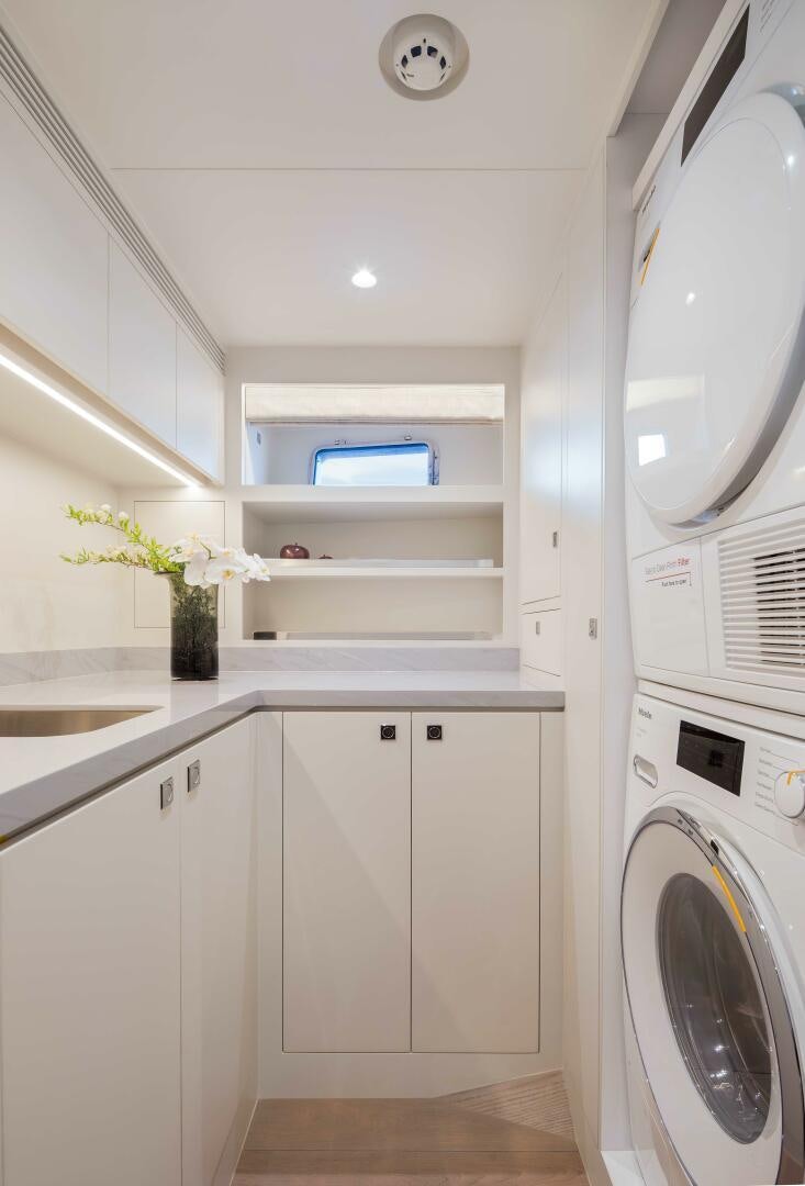 a white kitchen with white cabinets aboard FD80-614 Yacht for Sale