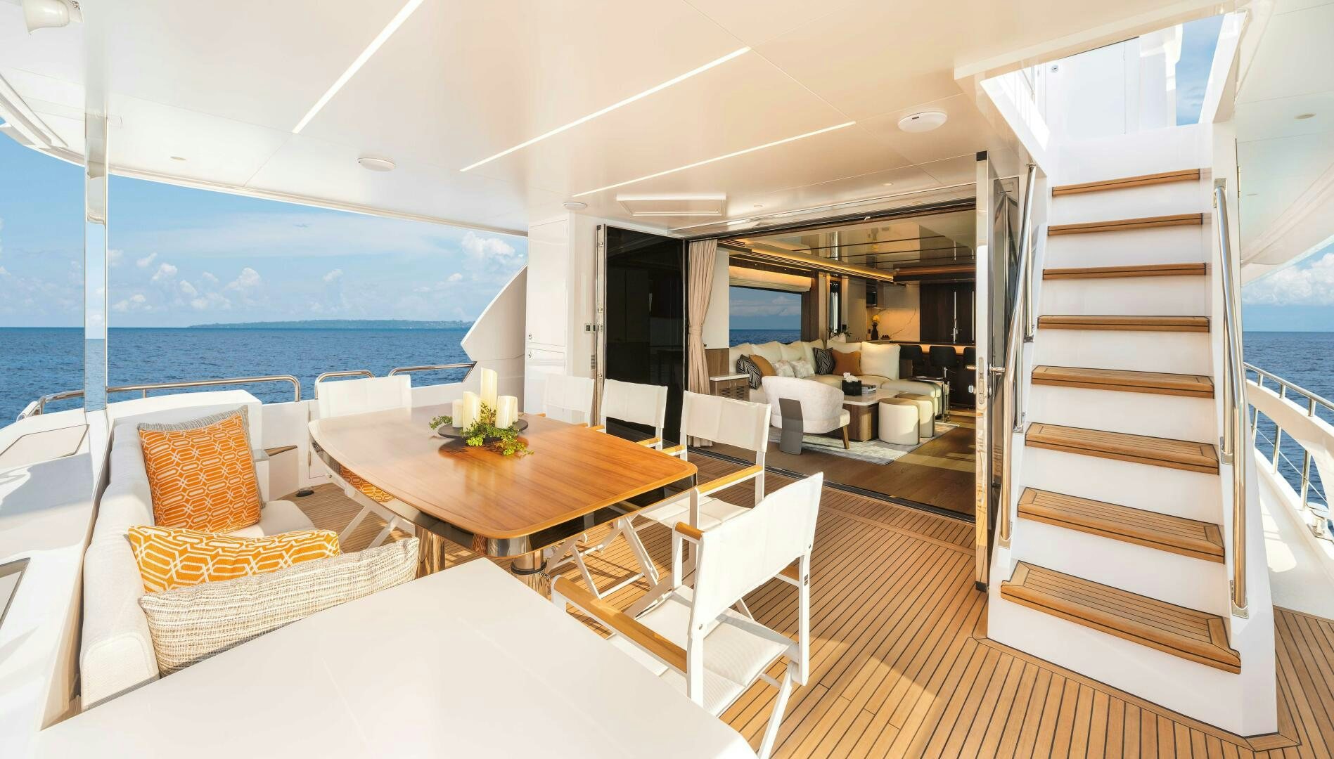 a room with a table chairs and a view of the ocean aboard FD80-614 Yacht for Sale