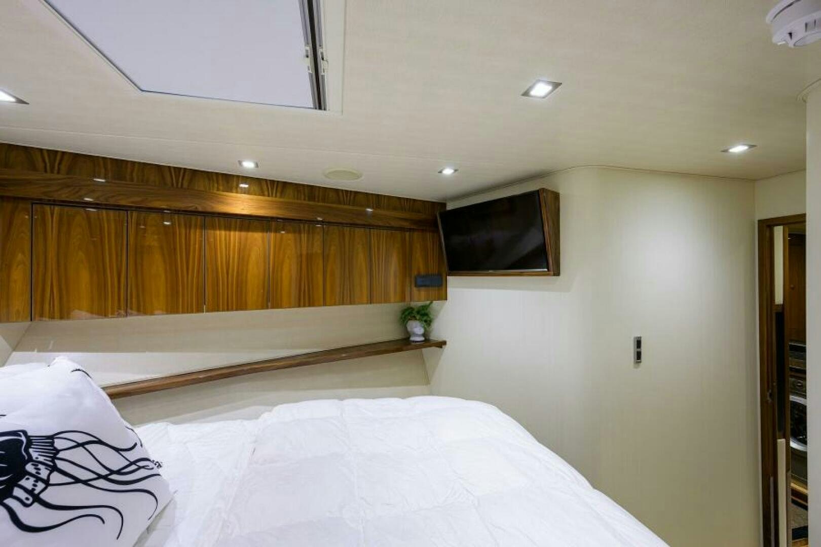 a room with a bed and a wood wall aboard MIRAGE DELETE Yacht for Sale