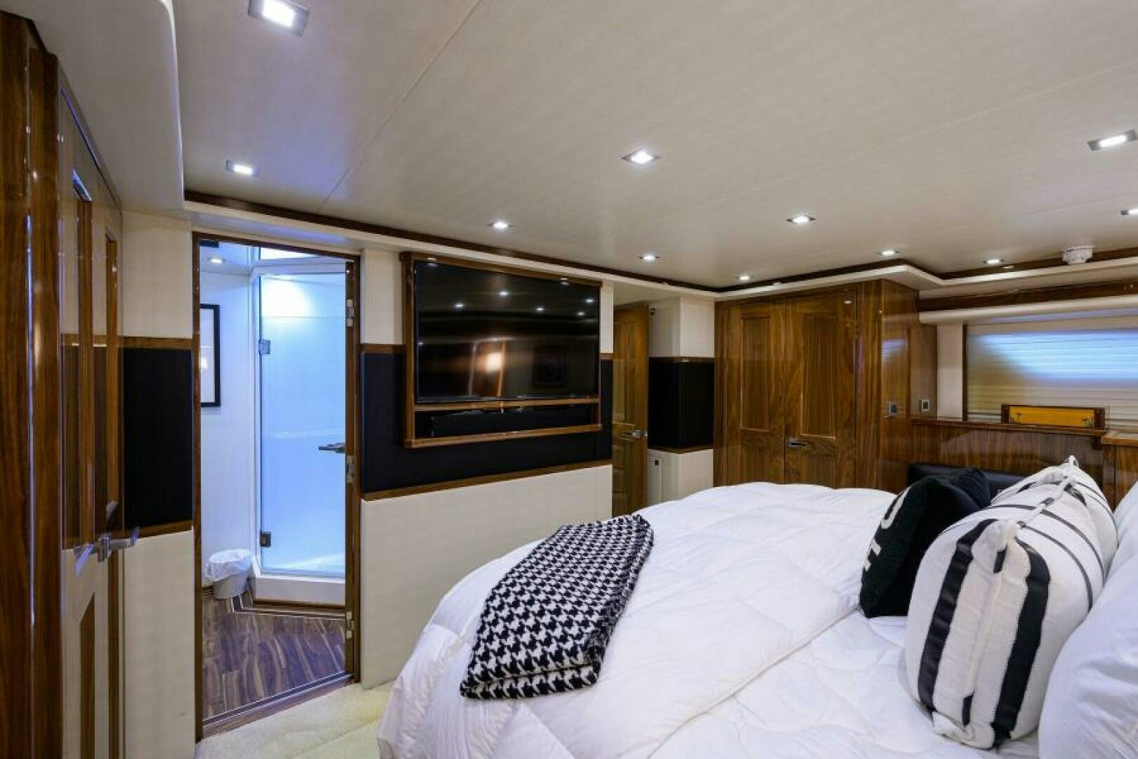 a bedroom with a large bed aboard MIRAGE DELETE Yacht for Sale