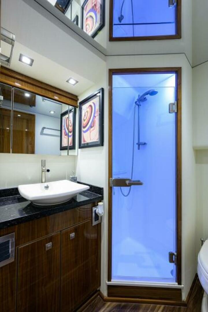 a bathroom with a blue shower door aboard MIRAGE DELETE Yacht for Sale