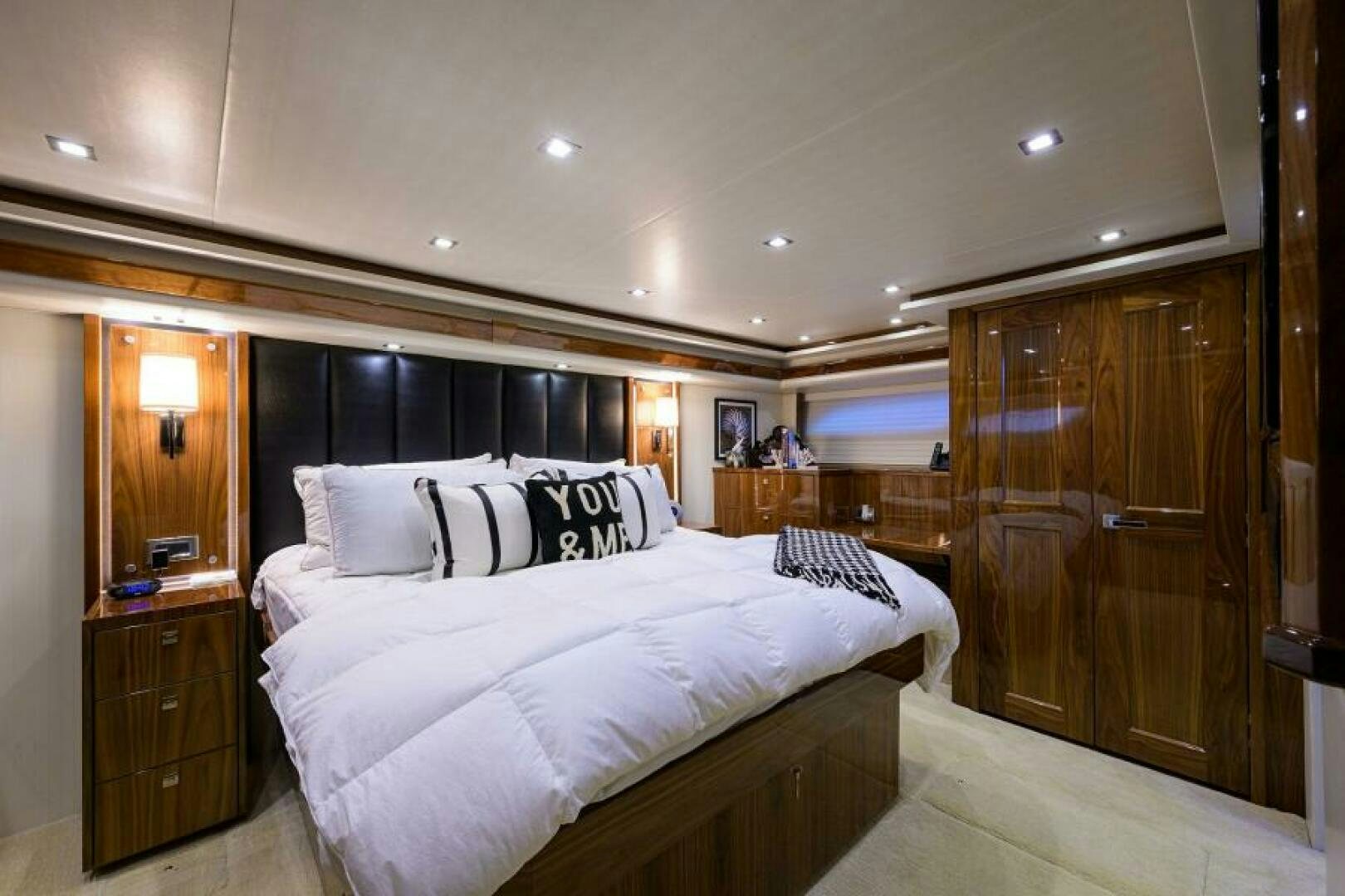 a bedroom with a bed and a closet aboard MIRAGE DELETE Yacht for Sale