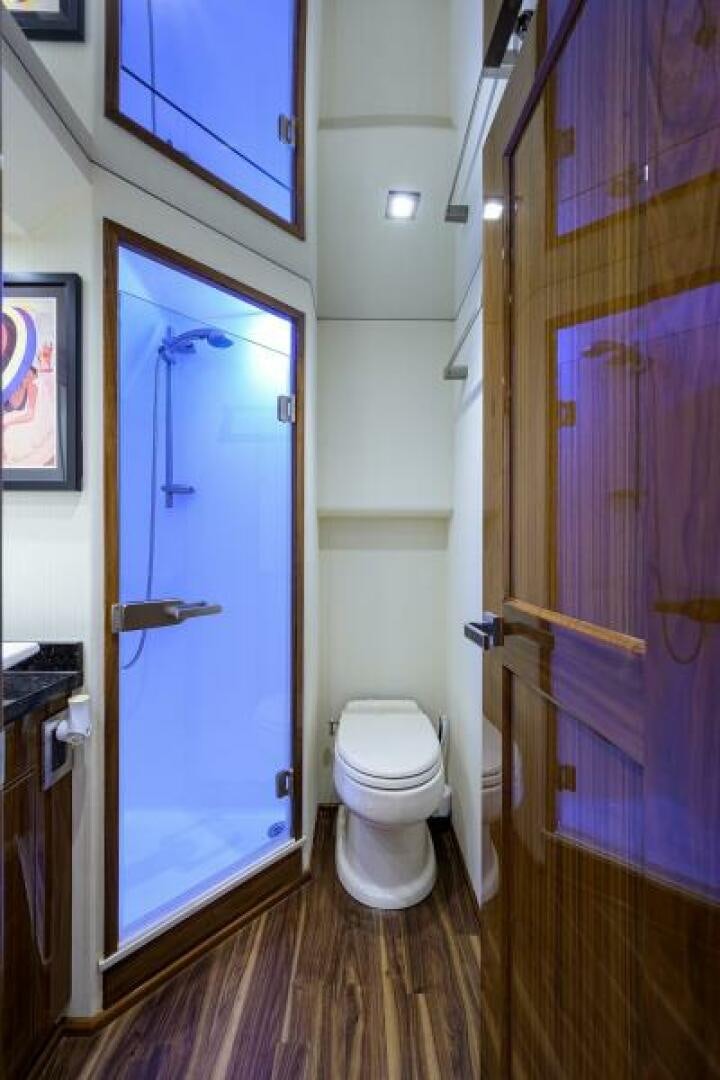 a bathroom with a blue door aboard MIRAGE DELETE Yacht for Sale
