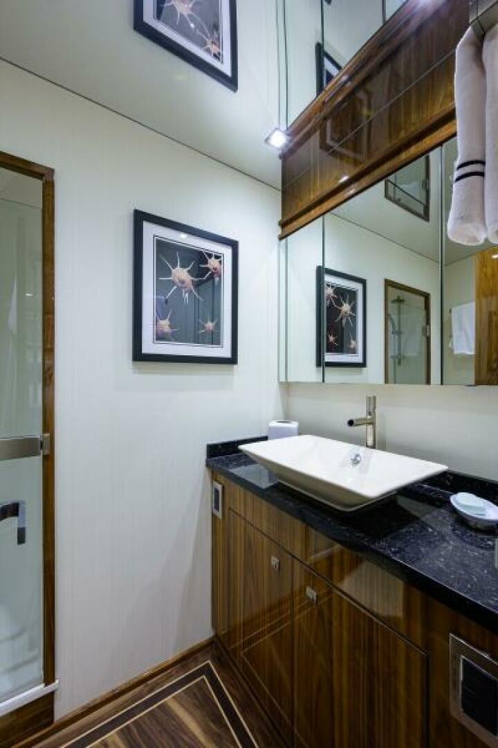 a bathroom with a sink and a mirror aboard MIRAGE DELETE Yacht for Sale