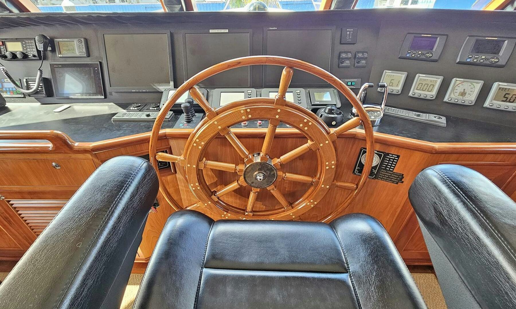 a wooden steering wheel in a car aboard MY KIMBERLY Yacht for Sale