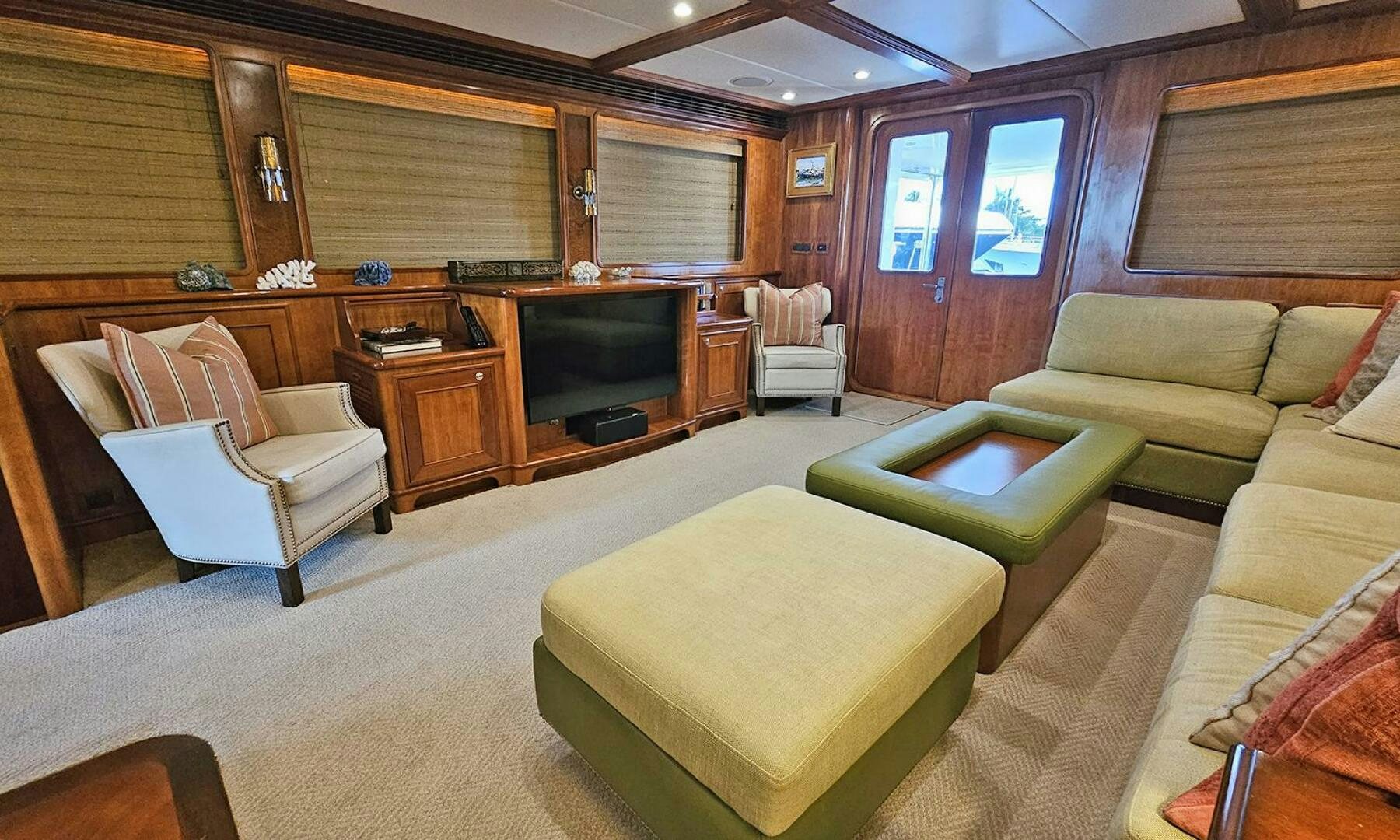 a living room with a couch and a television aboard MY KIMBERLY Yacht for Sale