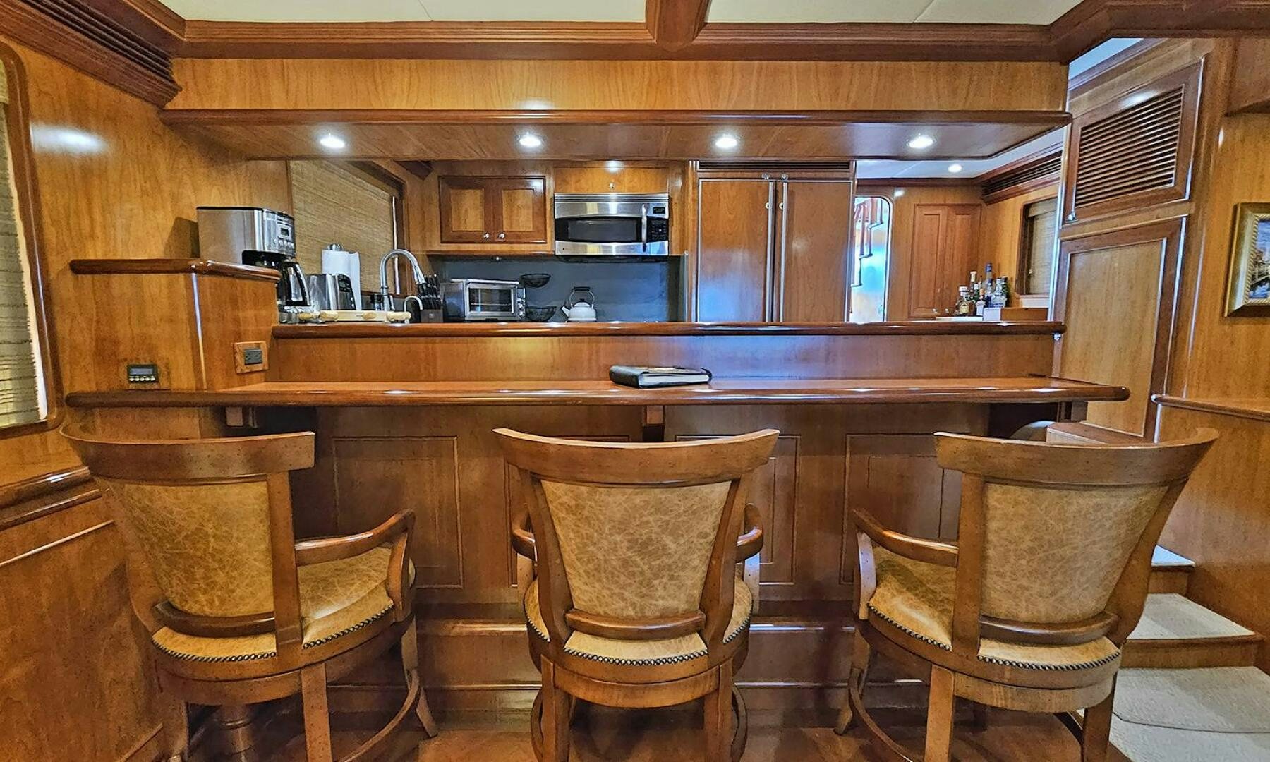 a kitchen with wooden cabinets aboard MY KIMBERLY Yacht for Sale