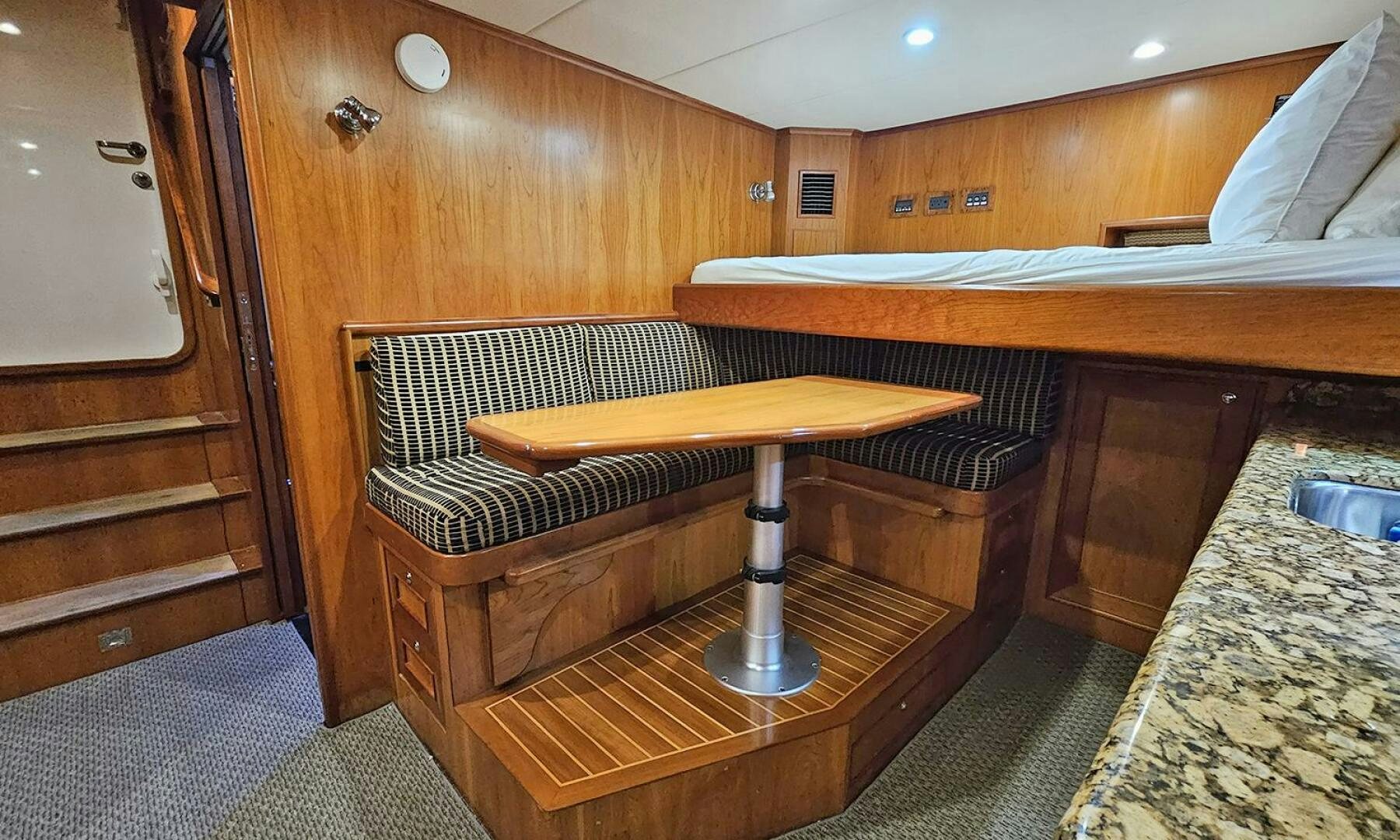 a room with a bed and a table aboard MY KIMBERLY Yacht for Sale