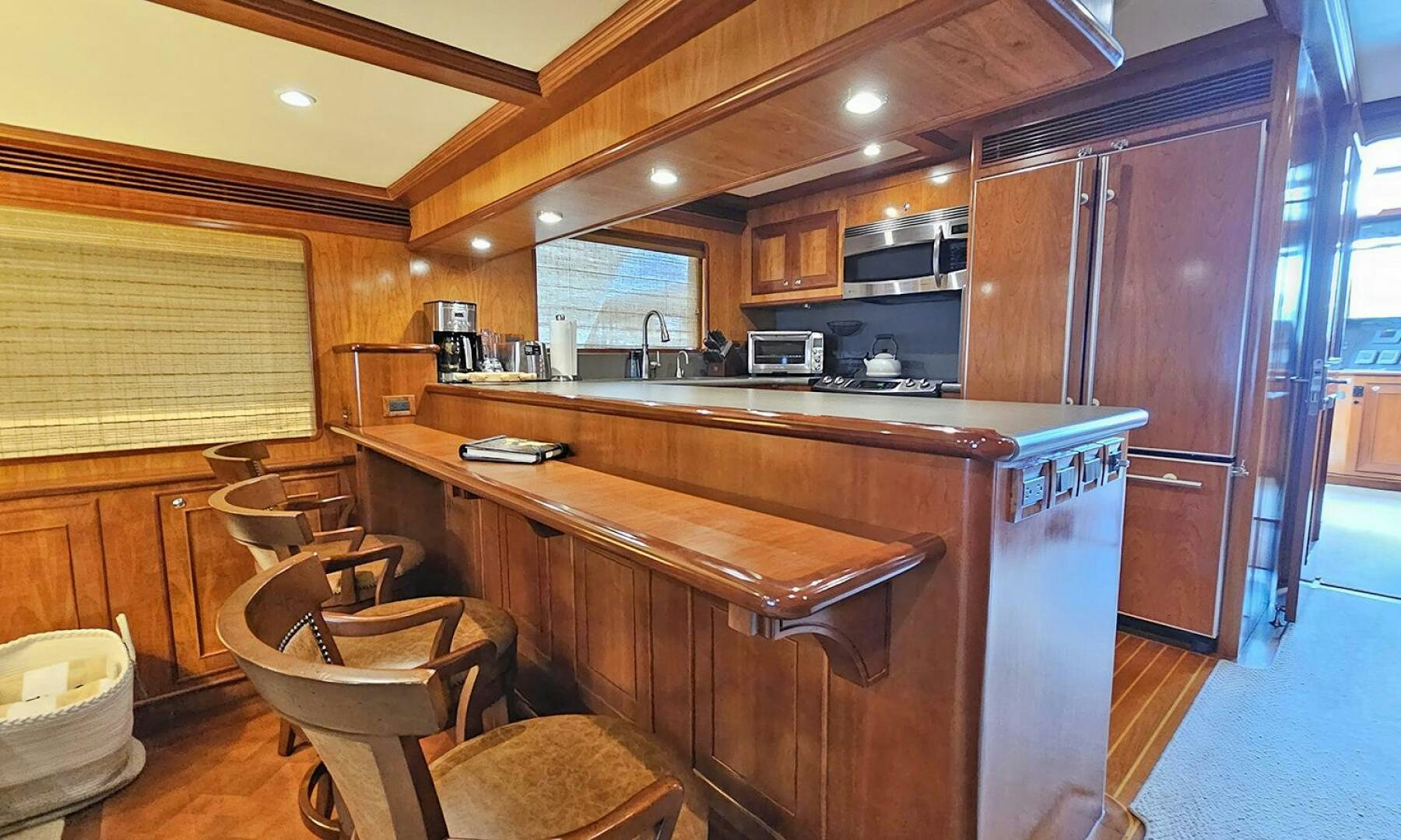 a kitchen with a bar and refrigerator aboard MY KIMBERLY Yacht for Sale