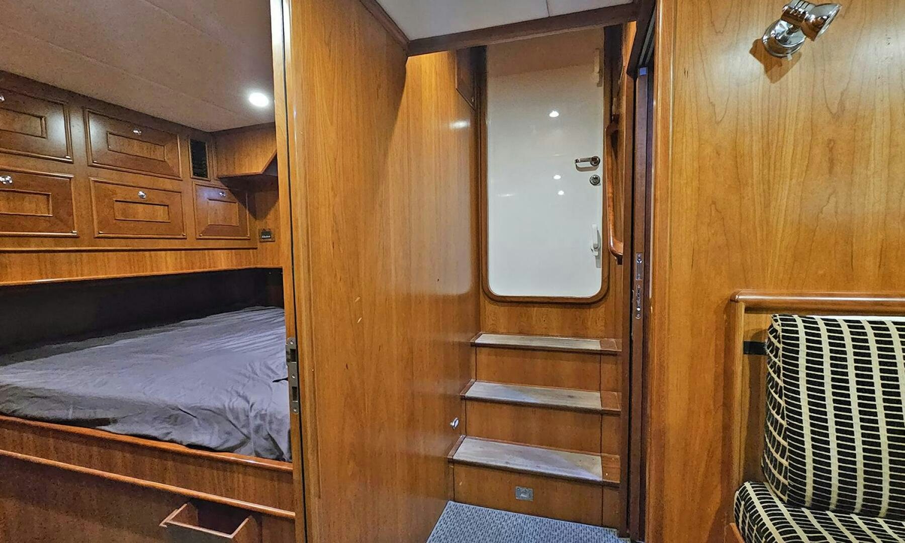 a closet with a bed and a window aboard MY KIMBERLY Yacht for Sale