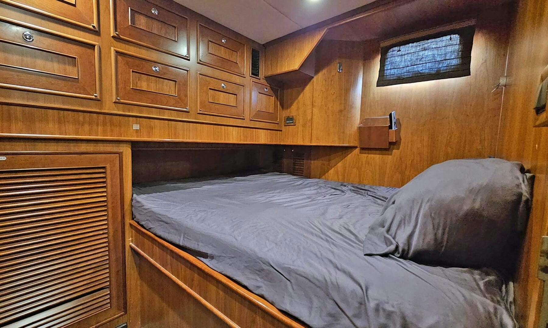 a bed with wooden drawers aboard MY KIMBERLY Yacht for Sale