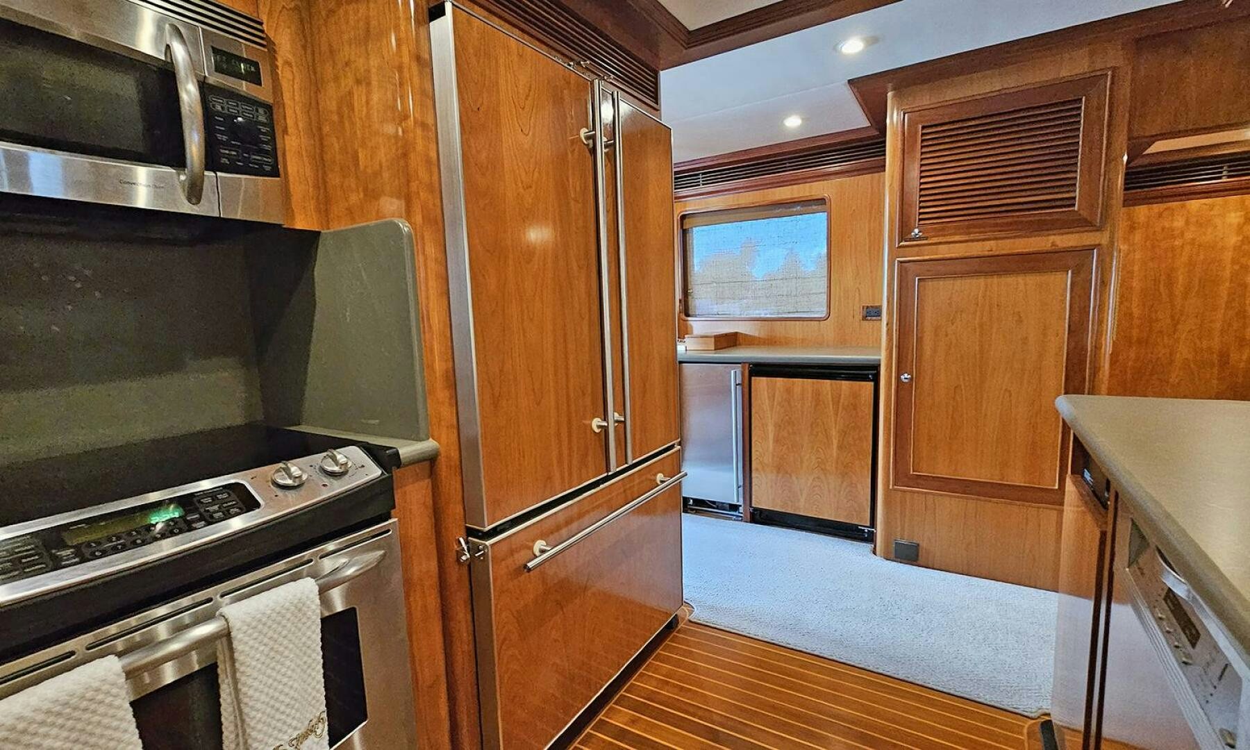 a kitchen with wooden cabinets aboard MY KIMBERLY Yacht for Sale
