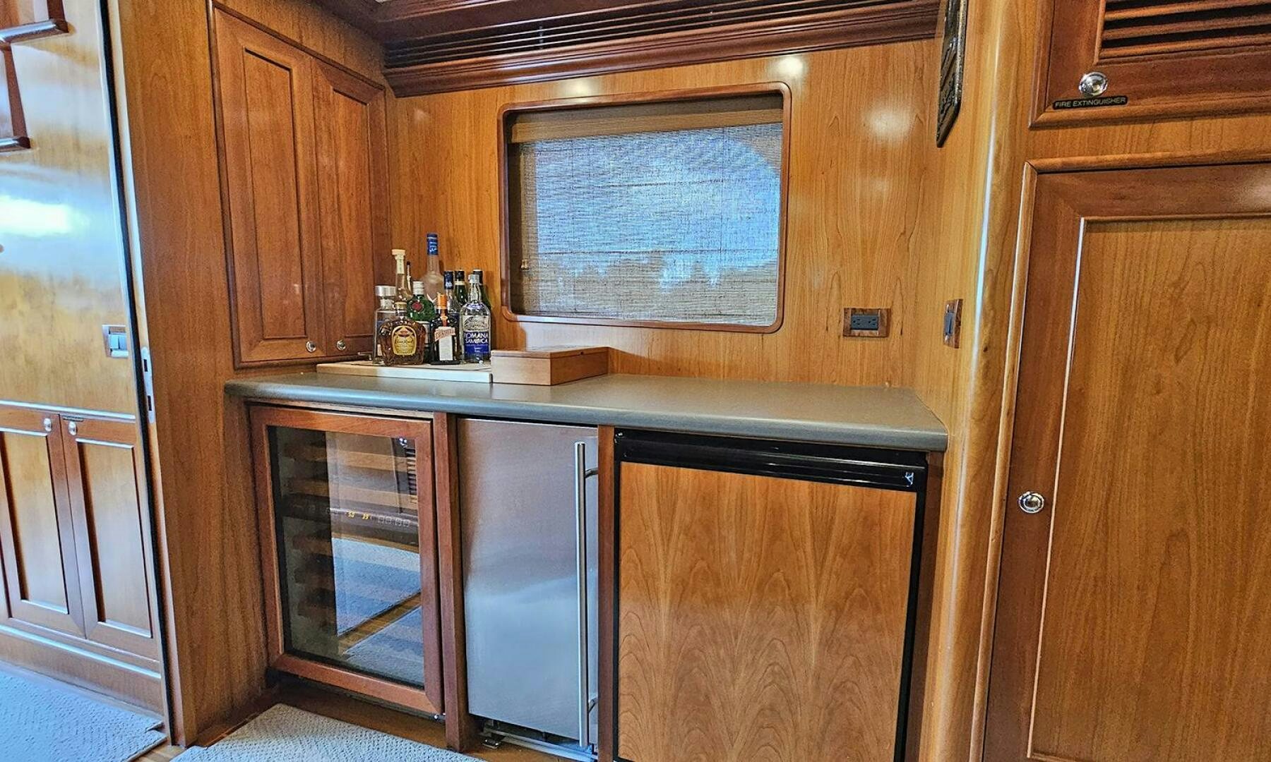 a kitchen with wooden cabinets aboard MY KIMBERLY Yacht for Sale