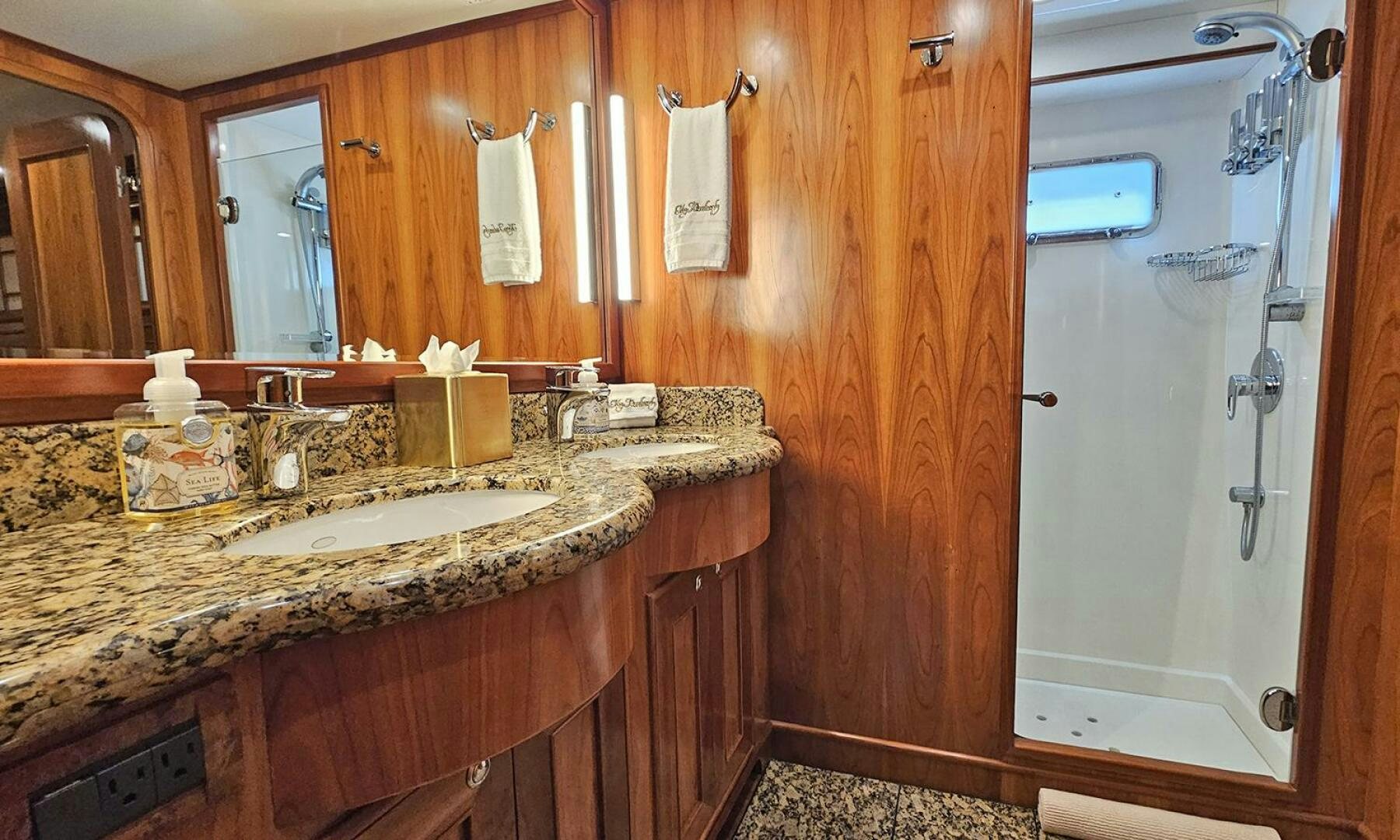 a bathroom with a countertop sink and wooden cabinets aboard MY KIMBERLY Yacht for Sale