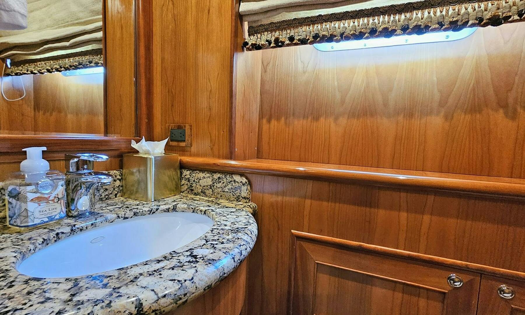 a bathroom with a sink and a mirror aboard MY KIMBERLY Yacht for Sale
