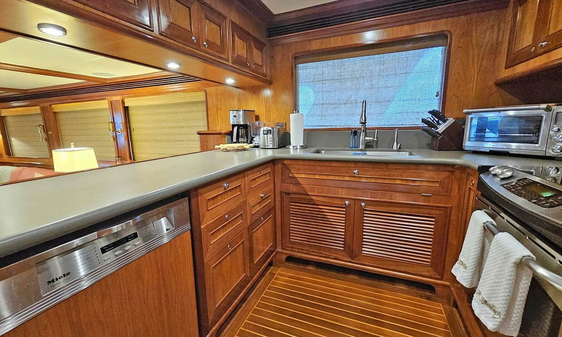 a kitchen with wooden cabinets aboard MY KIMBERLY Yacht for Sale