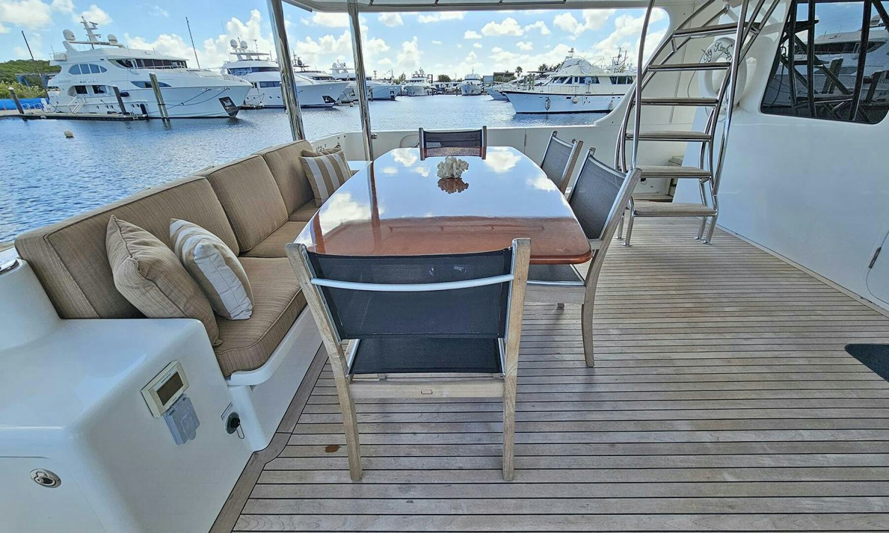 a table and chairs on a deck aboard MY KIMBERLY Yacht for Sale