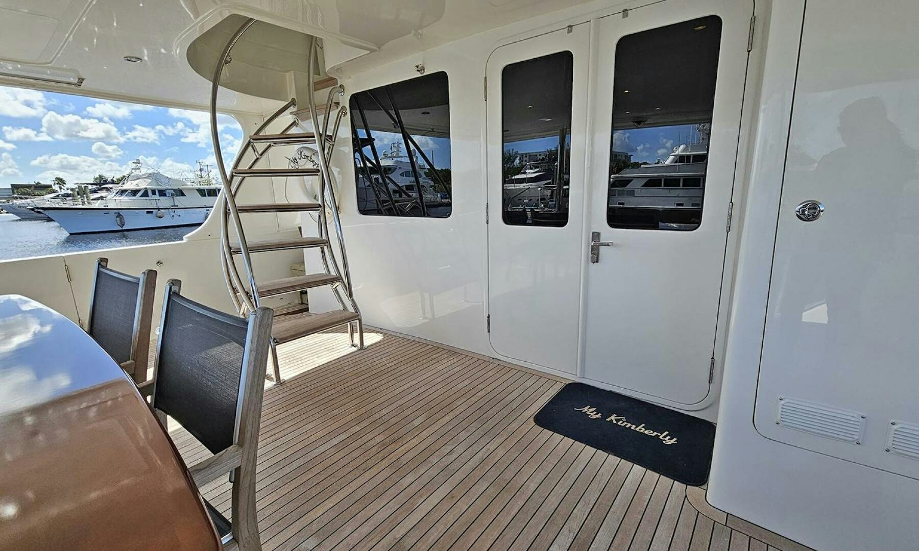 a white boat on a deck aboard MY KIMBERLY Yacht for Sale