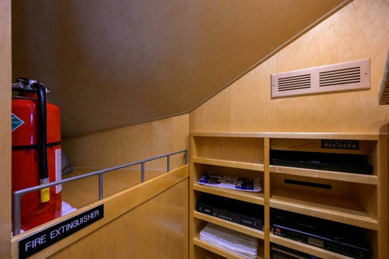 a red fire extinguisher on a shelf aboard EGARIM Yacht for Sale