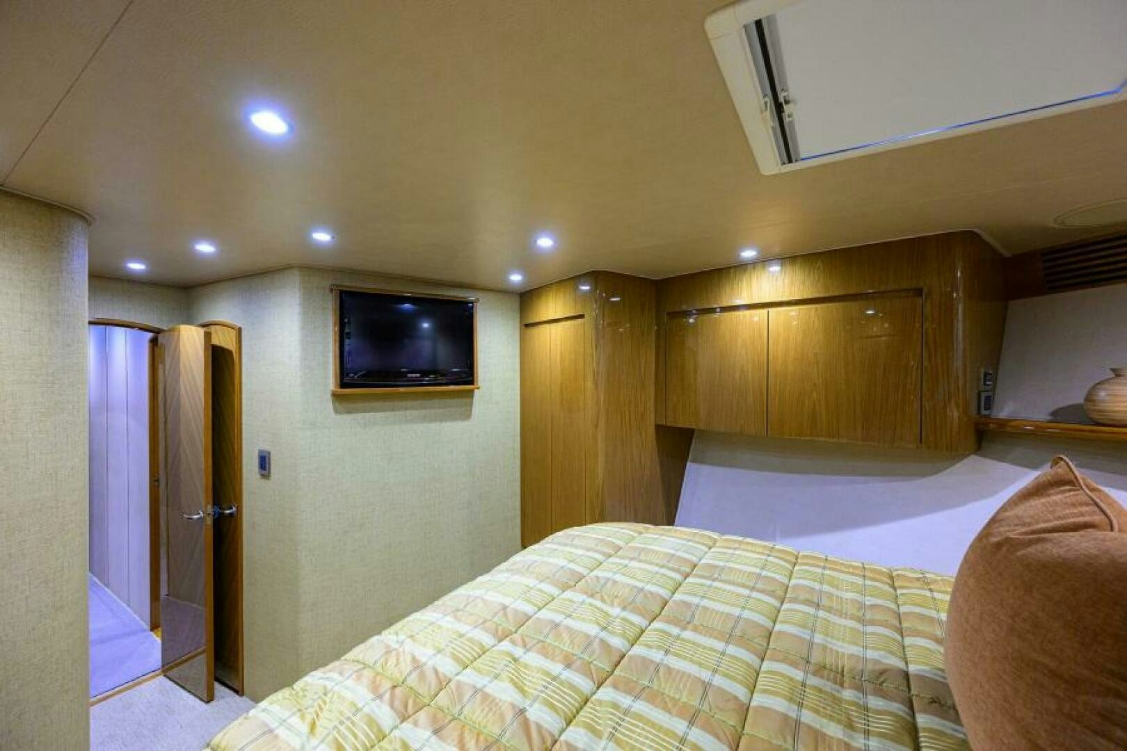 a bedroom with a tv on the wall aboard EGARIM Yacht for Sale