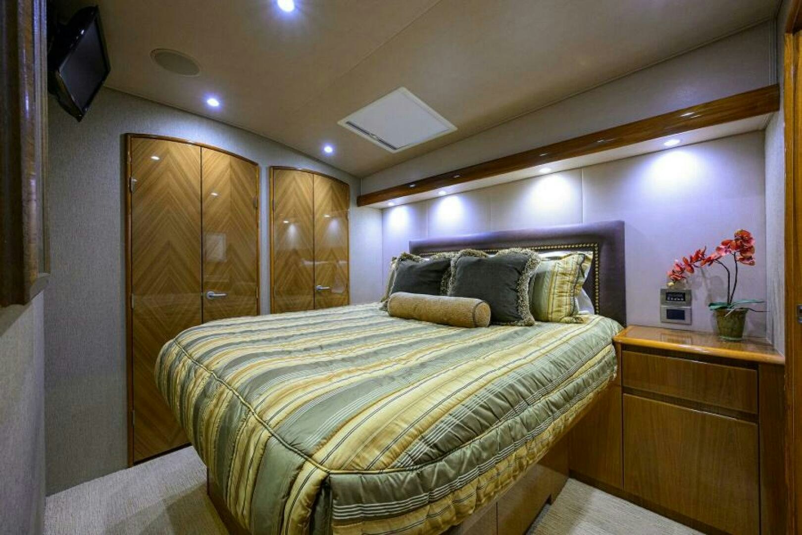 a bed with a pillow and a television on top of it aboard EGARIM Yacht for Sale