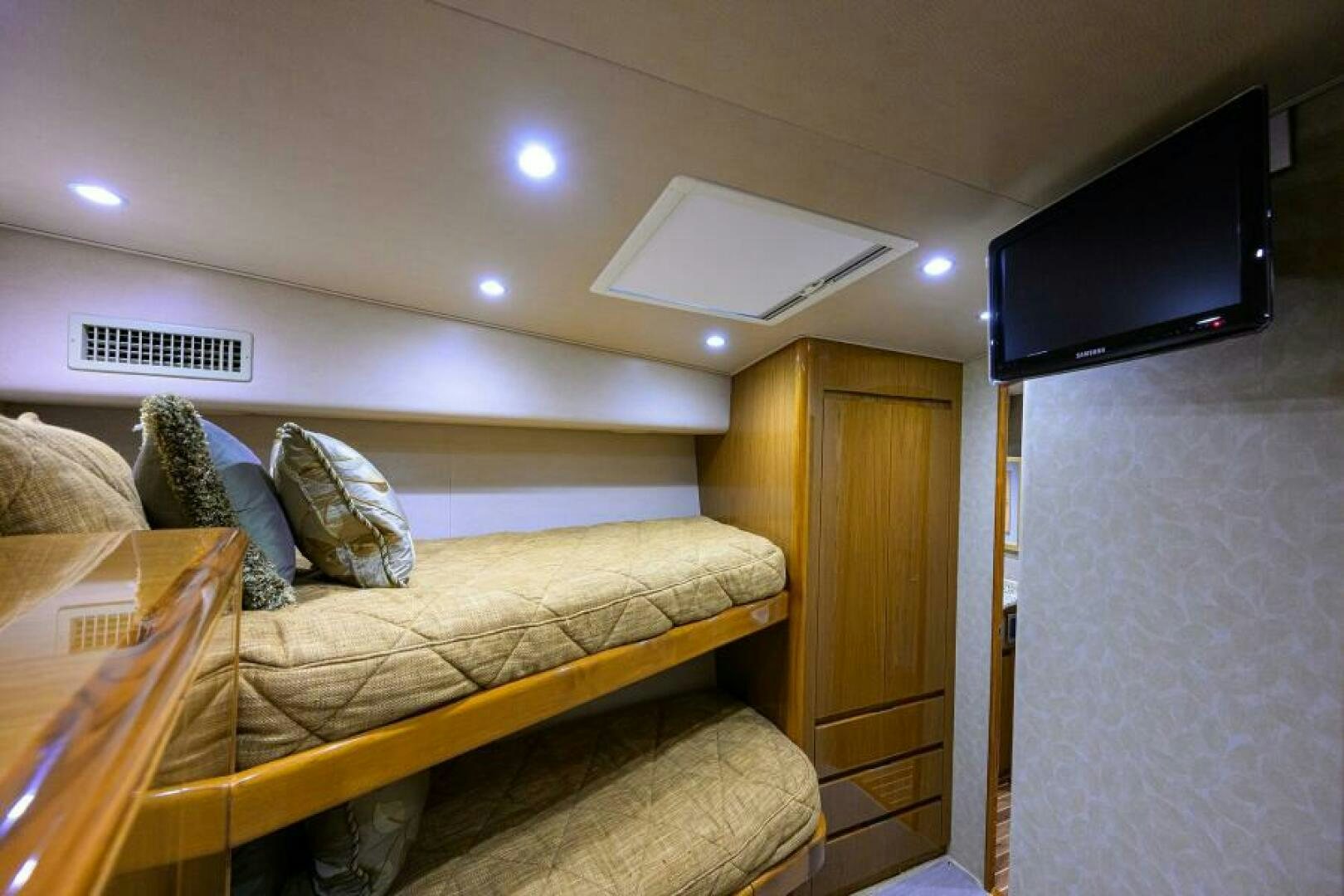 a bed with a tv on the wall aboard EGARIM Yacht for Sale
