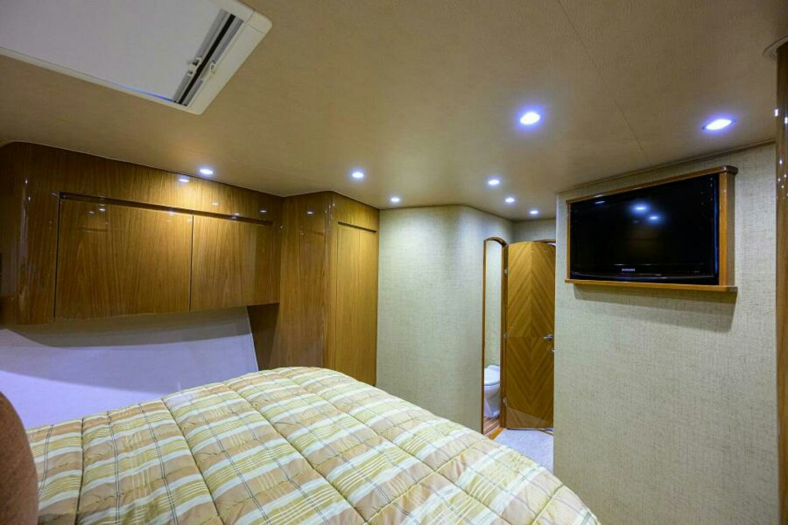 a bedroom with a tv on the wall aboard EGARIM Yacht for Sale