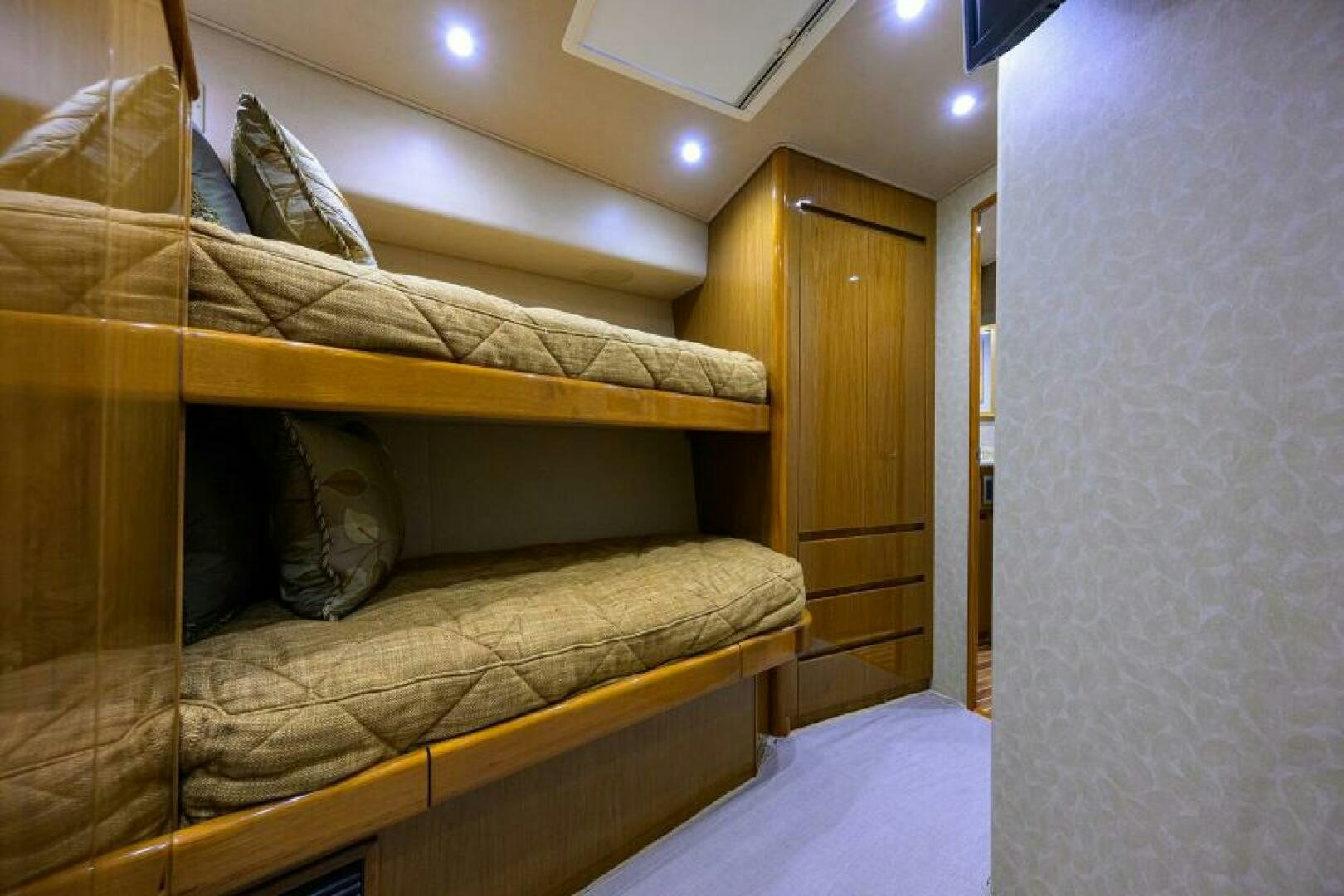 a bed with a brown comforter aboard EGARIM Yacht for Sale
