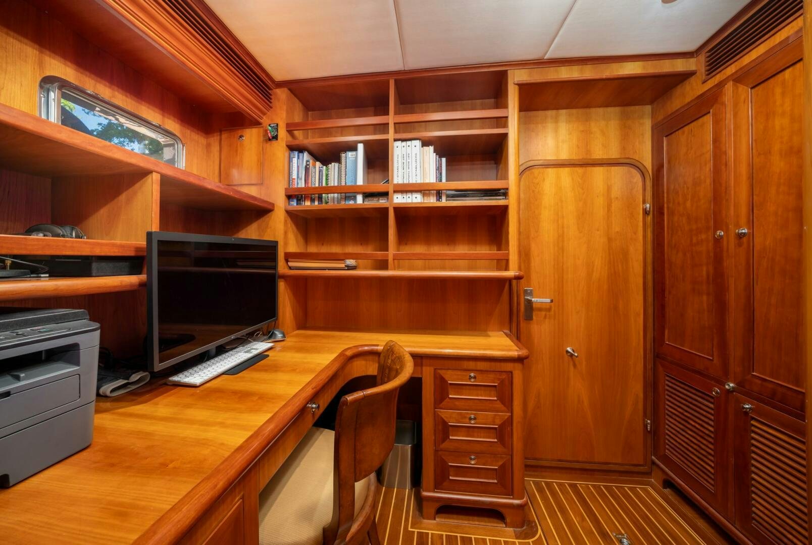 a room with wooden cabinets and a computer aboard BAD-LAD Yacht for Sale