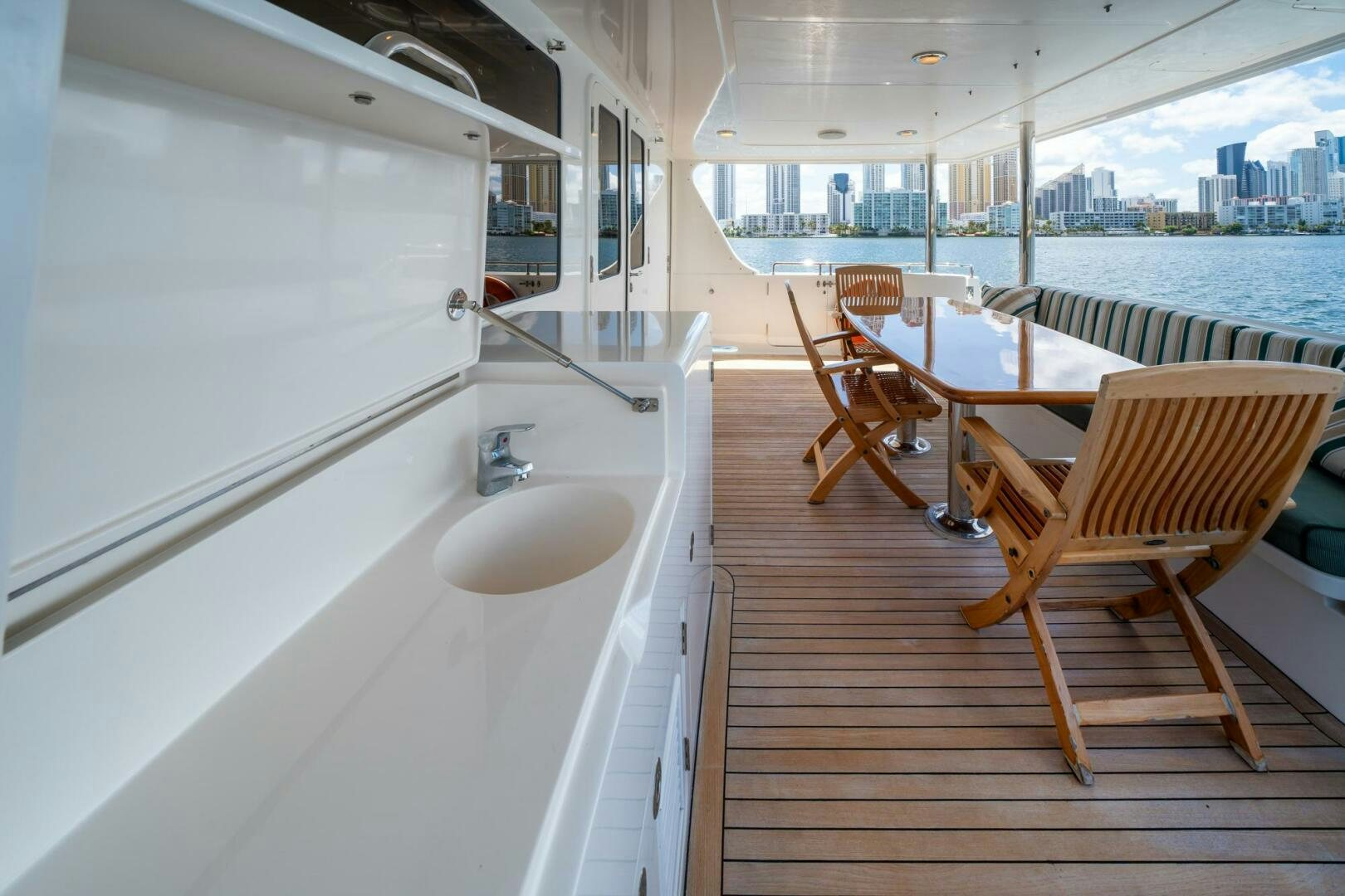 a kitchen with a table and chairs aboard BAD-LAD Yacht for Sale