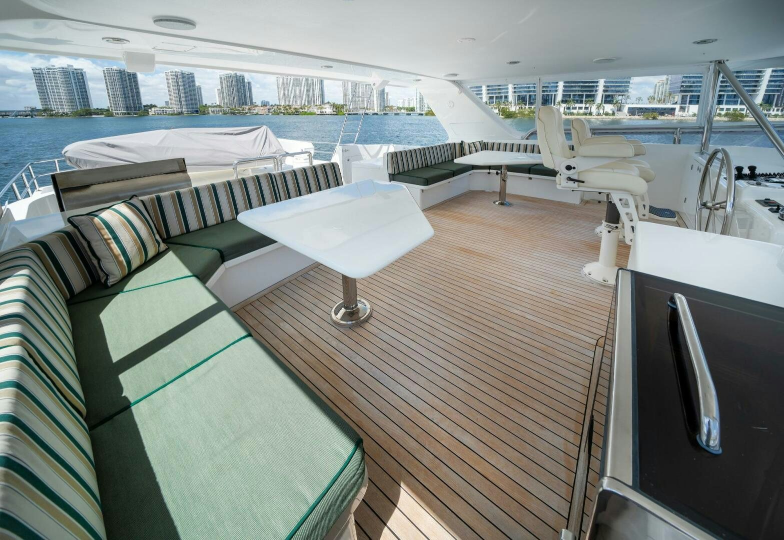 a deck with a deck and a pool aboard BAD-LAD Yacht for Sale