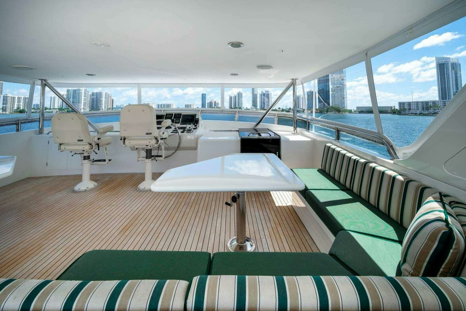 a boat with a table and chairs aboard BAD-LAD Yacht for Sale