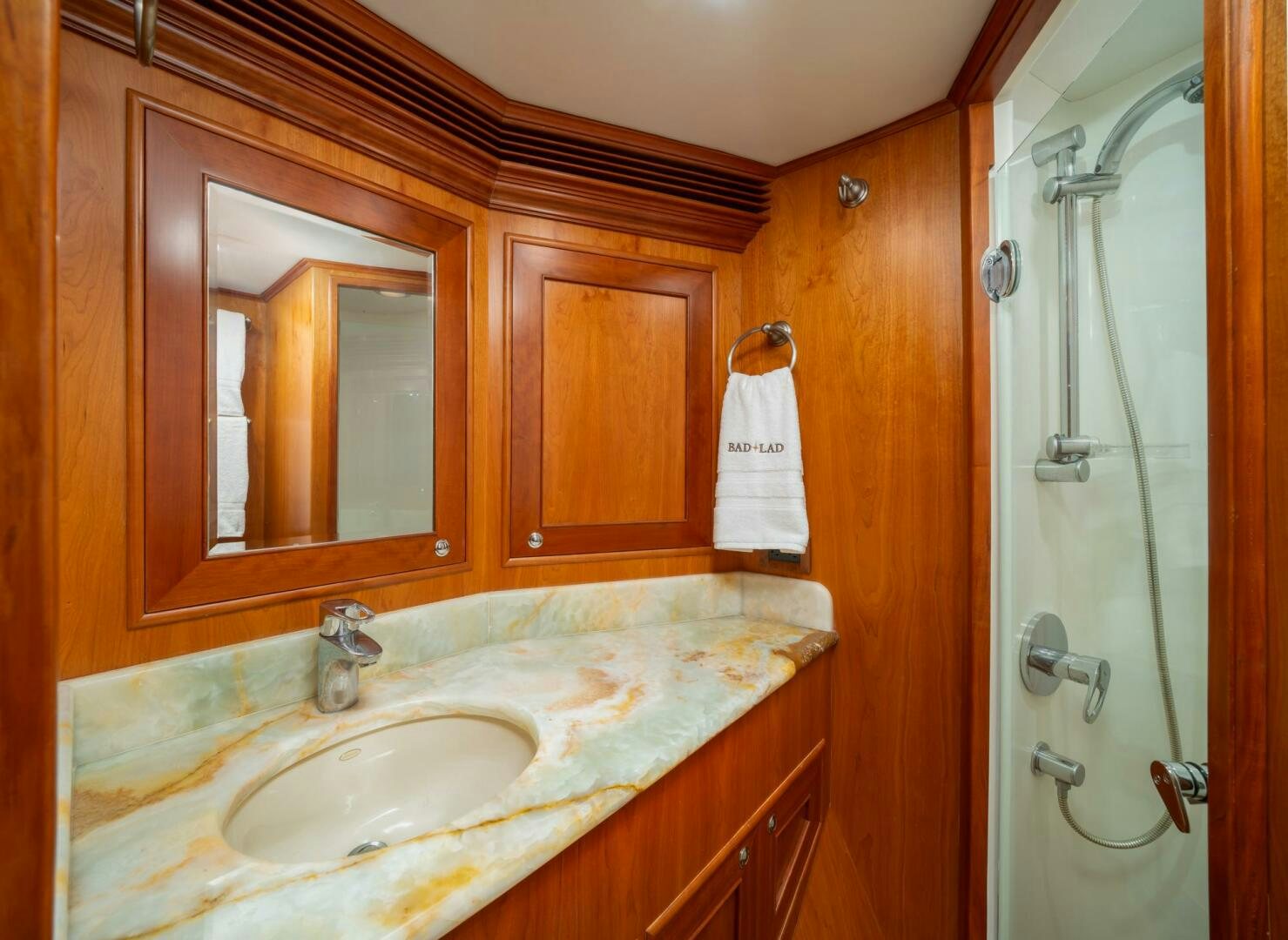 a bathroom with a sink and a shower unit aboard BAD-LAD Yacht for Sale