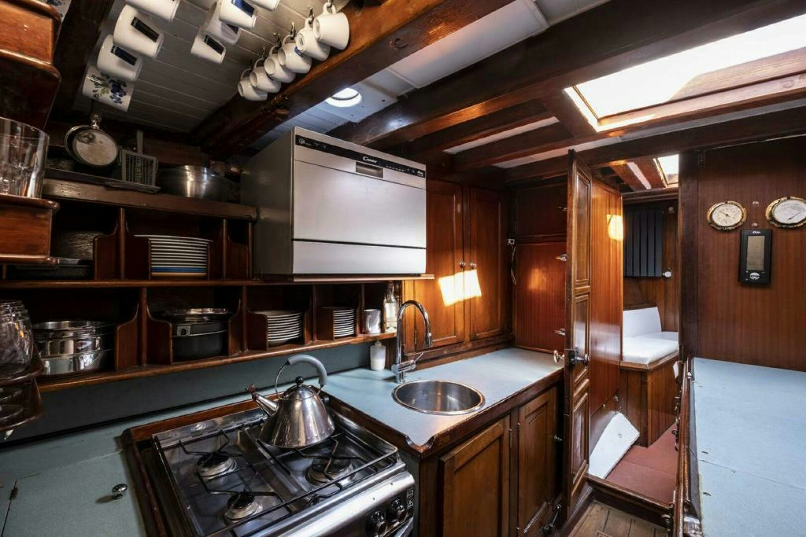a kitchen with wooden cabinets aboard JULIETTE Yacht for Sale
