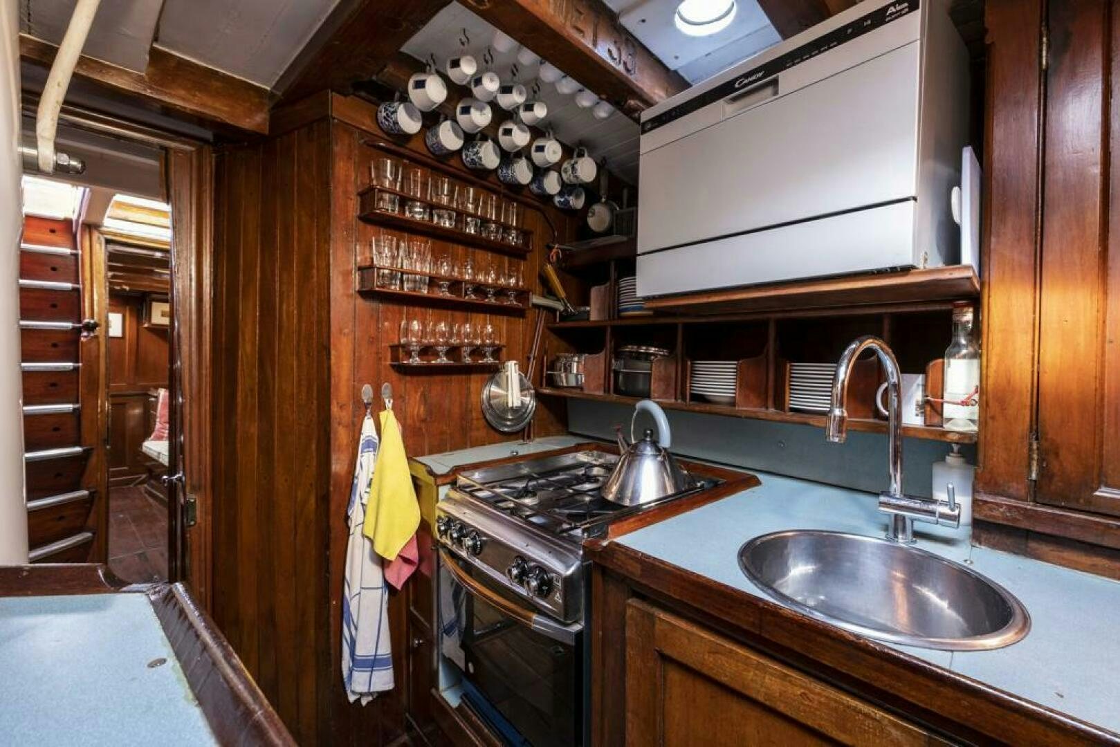 a kitchen with a sink and stove aboard JULIETTE Yacht for Sale