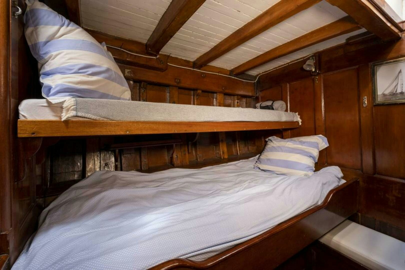 a bed with white sheets aboard JULIETTE Yacht for Sale