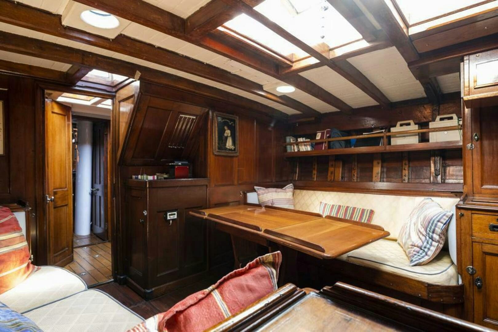 a room with a bed and desk aboard JULIETTE Yacht for Sale