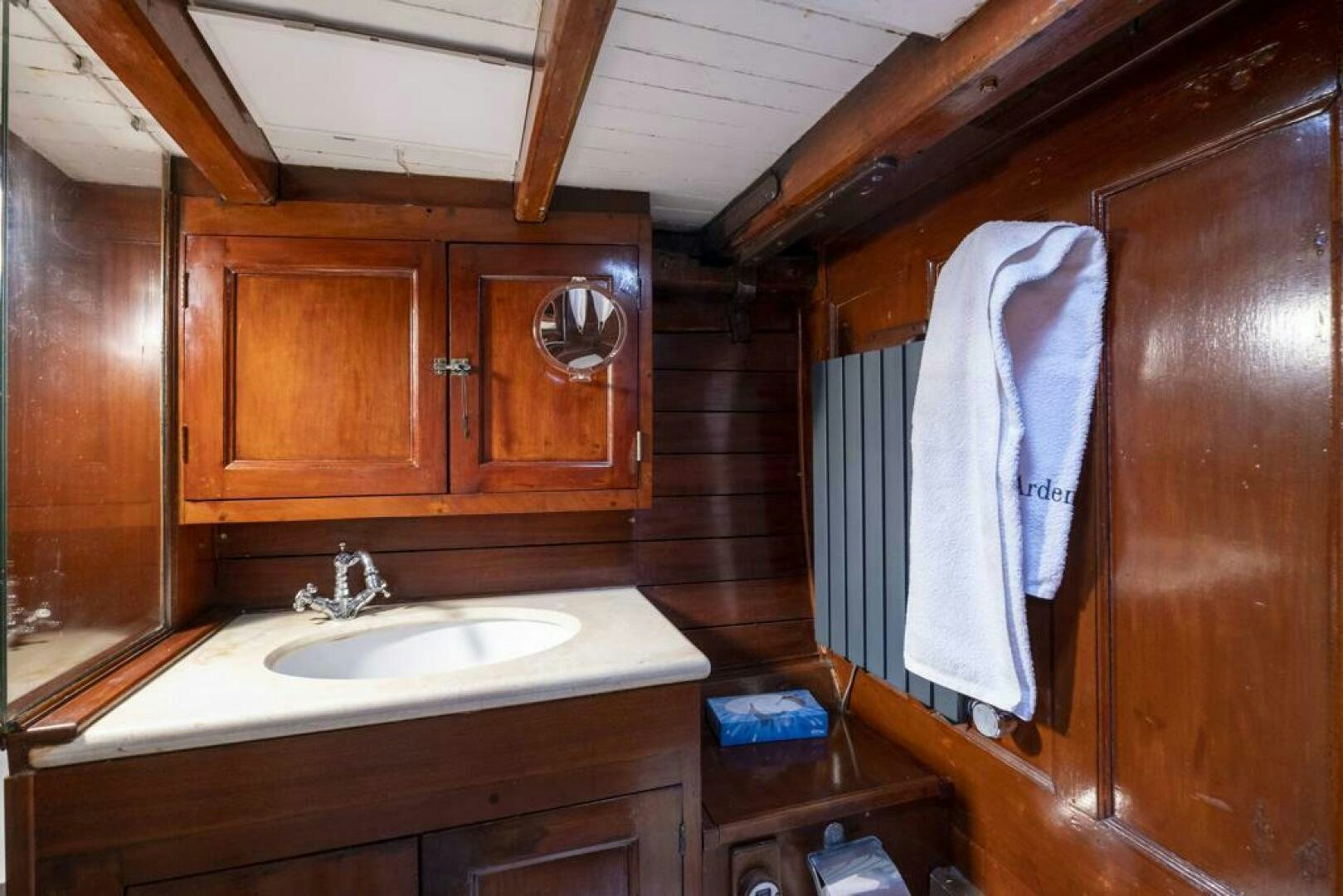 a bathroom with wooden cabinets aboard JULIETTE Yacht for Sale