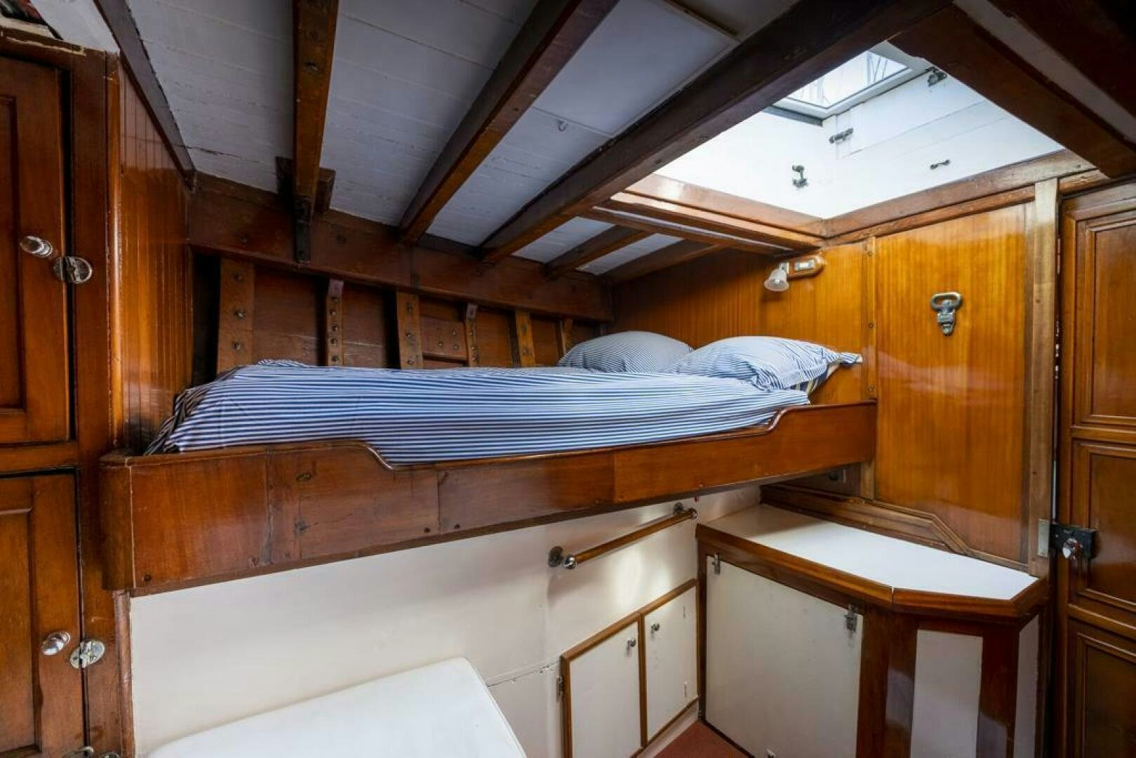 a bed in a wooden room aboard JULIETTE Yacht for Sale