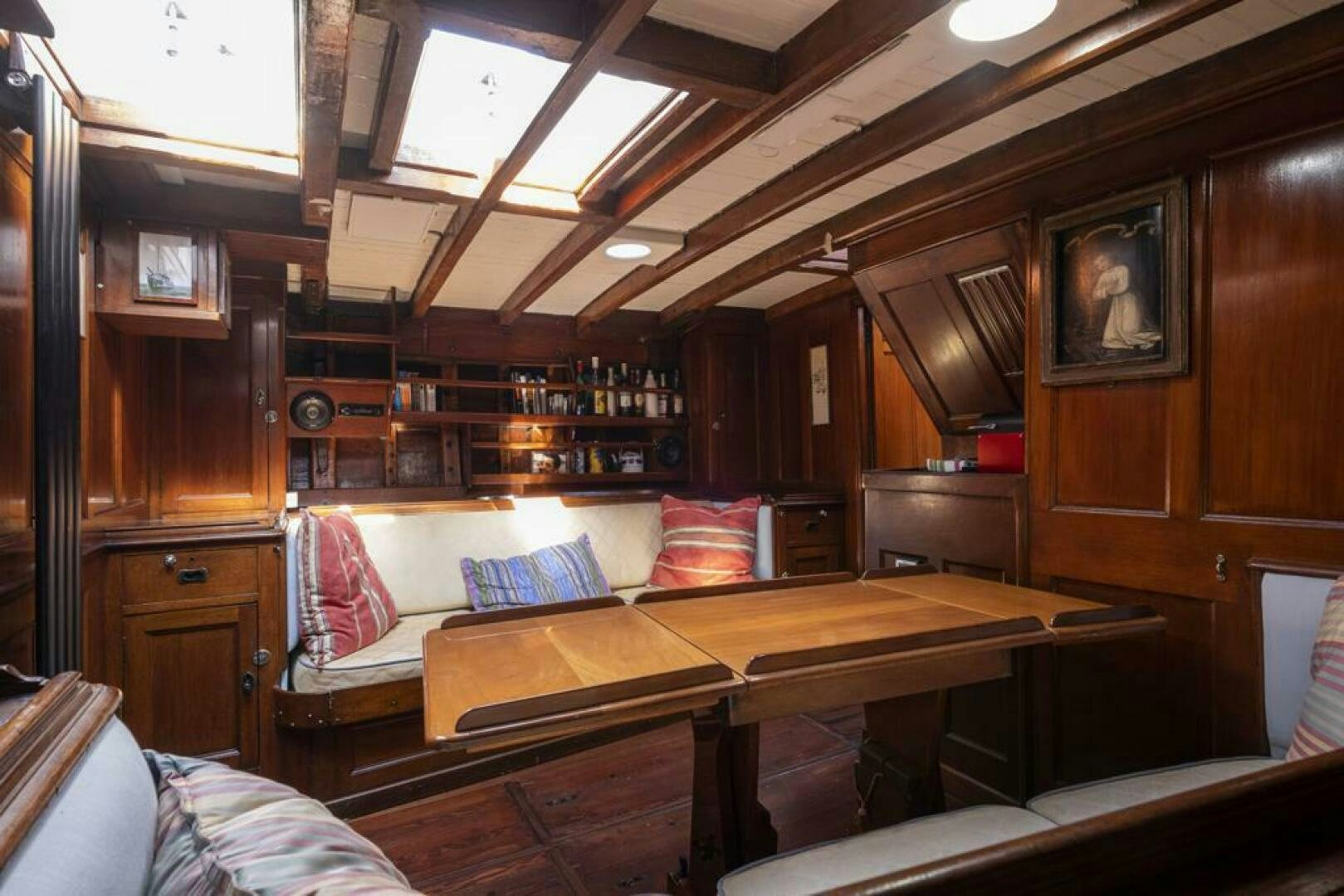 a room with a couch and a table aboard JULIETTE Yacht for Sale