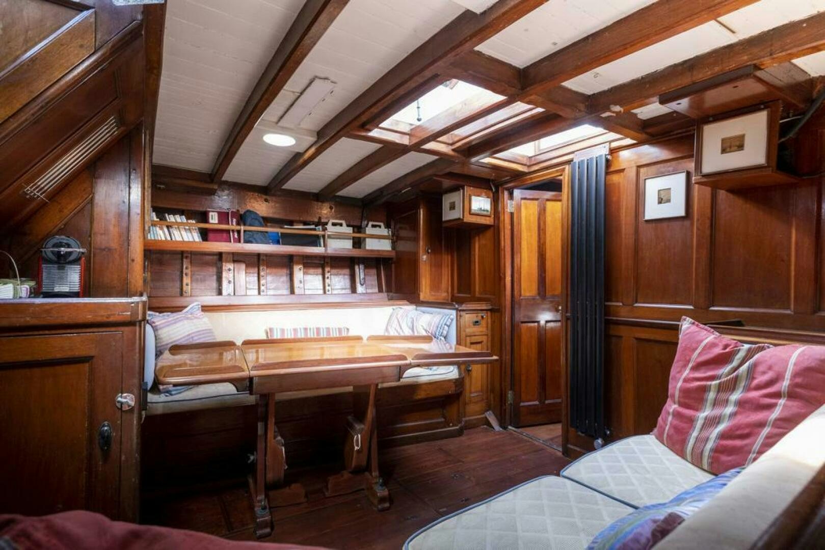 a cabin with a bed and desk aboard JULIETTE Yacht for Sale