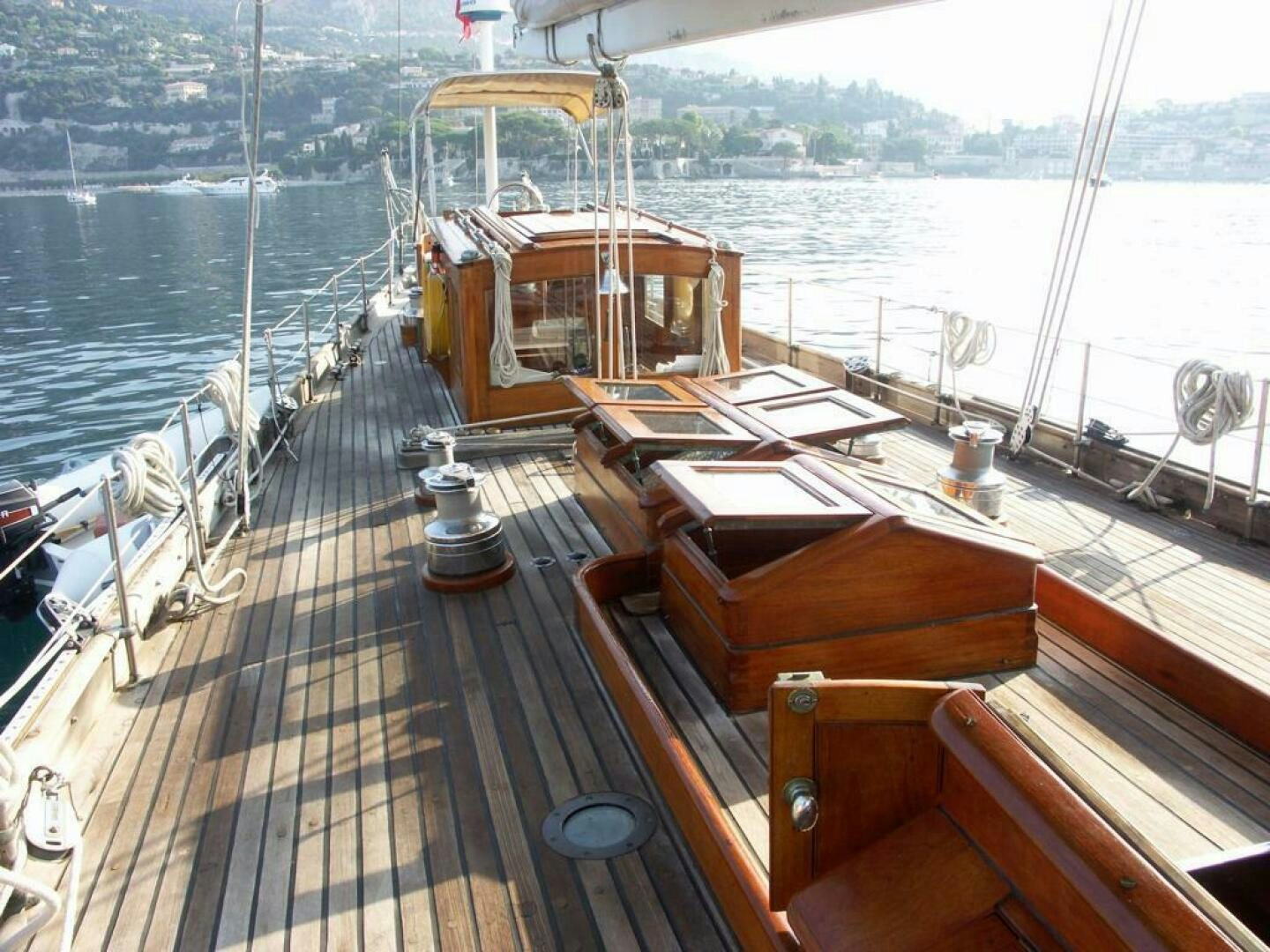 a deck with a deck and a large ship in the water aboard JULIETTE Yacht for Sale