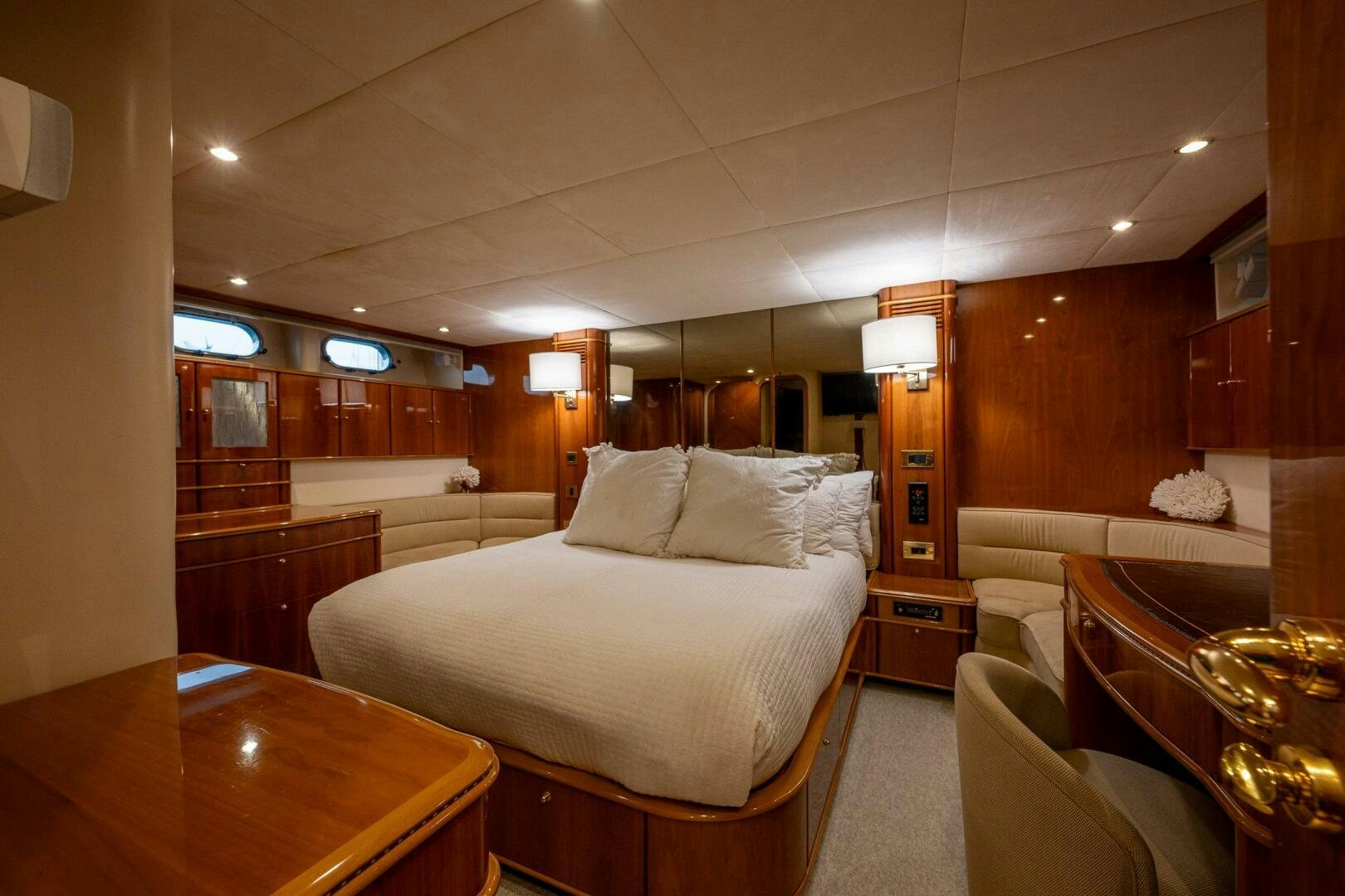 a room with a bed and a table aboard PEARL Yacht for Sale