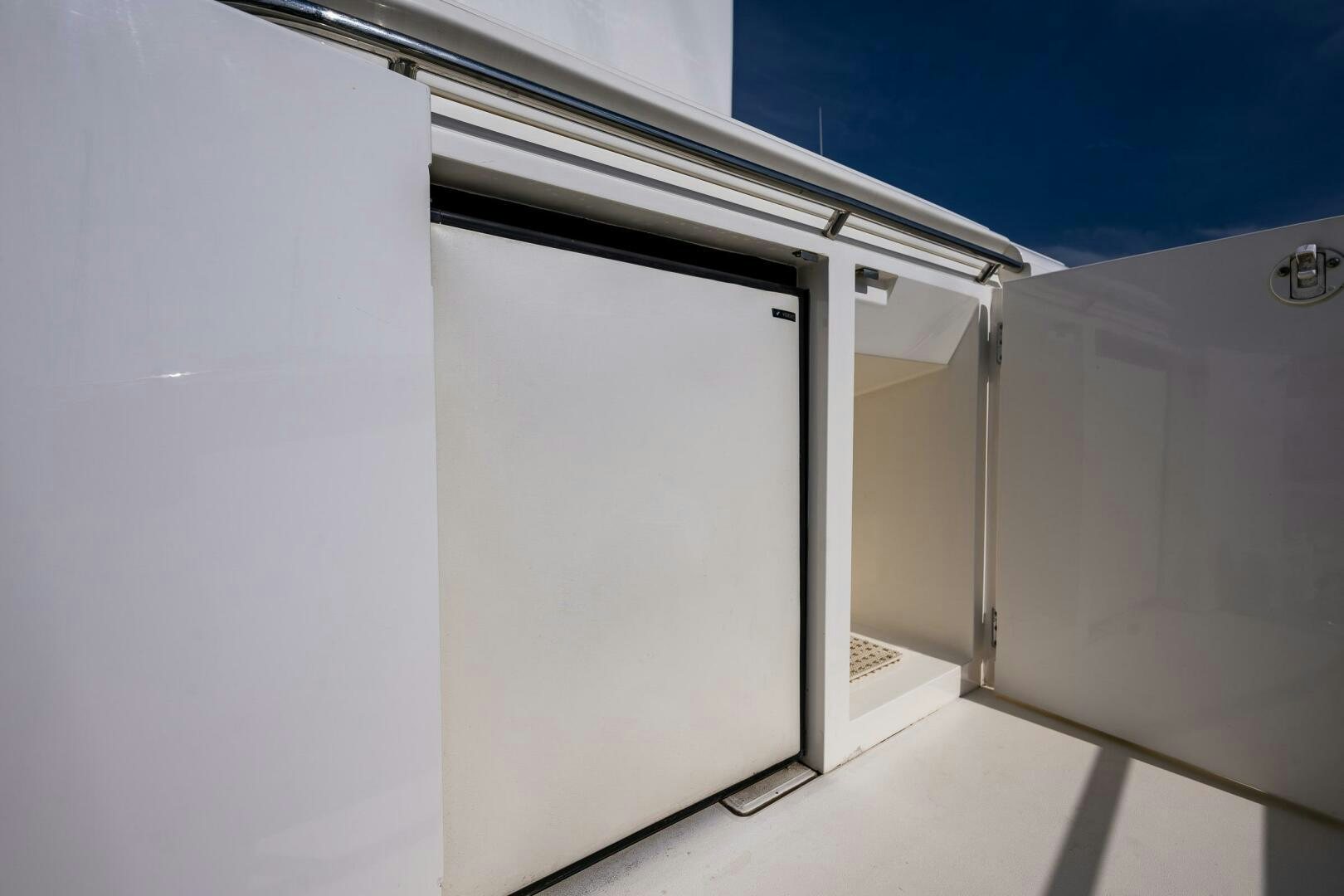 a white refrigerator in a kitchen aboard PEARL Yacht for Sale