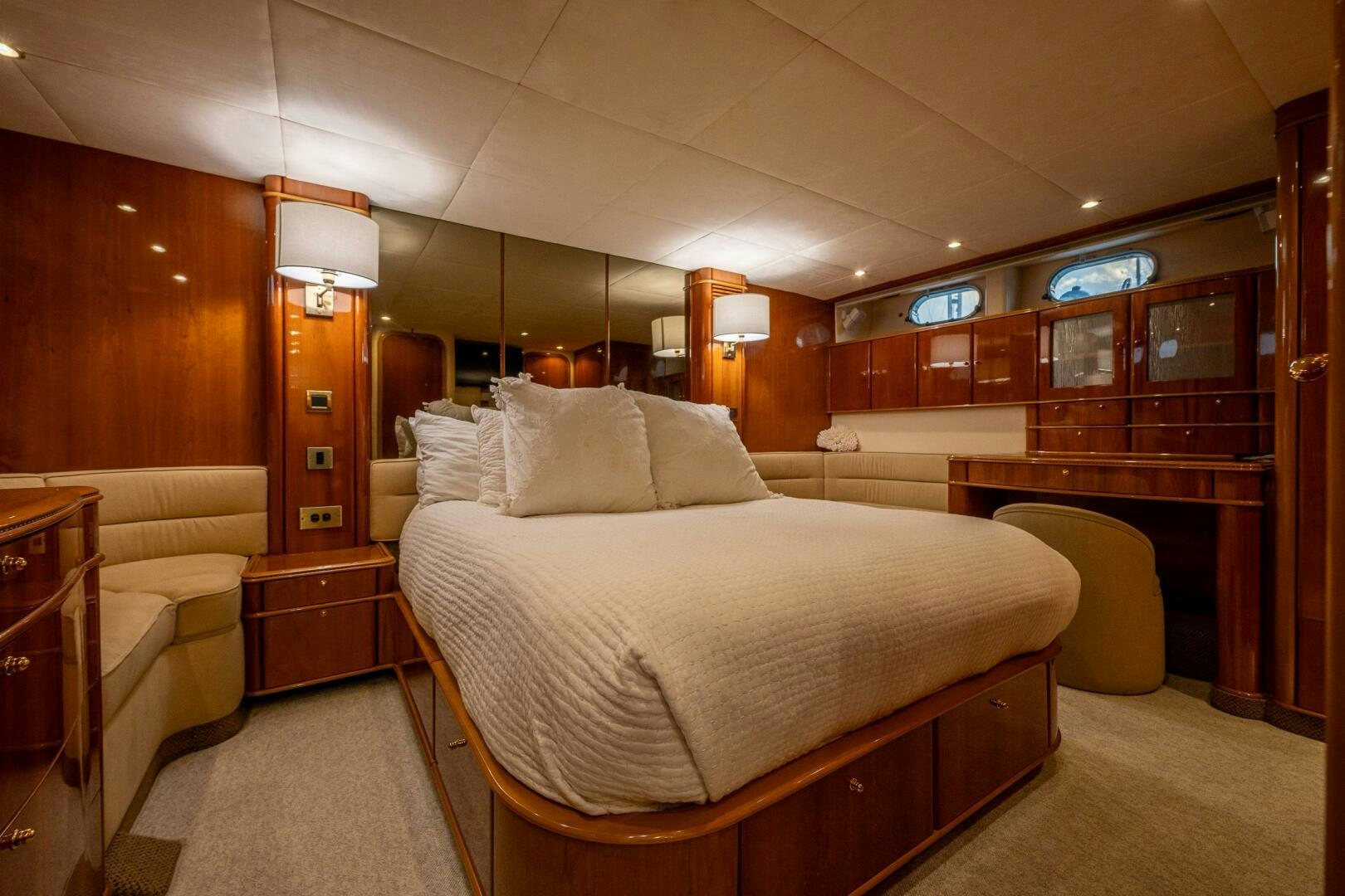 a room with a bed and a desk aboard PEARL Yacht for Sale