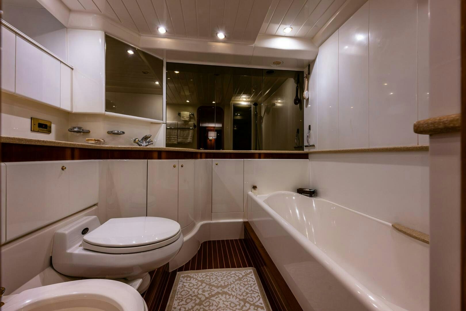 a bathroom with a tub toilet and sink aboard PEARL Yacht for Sale