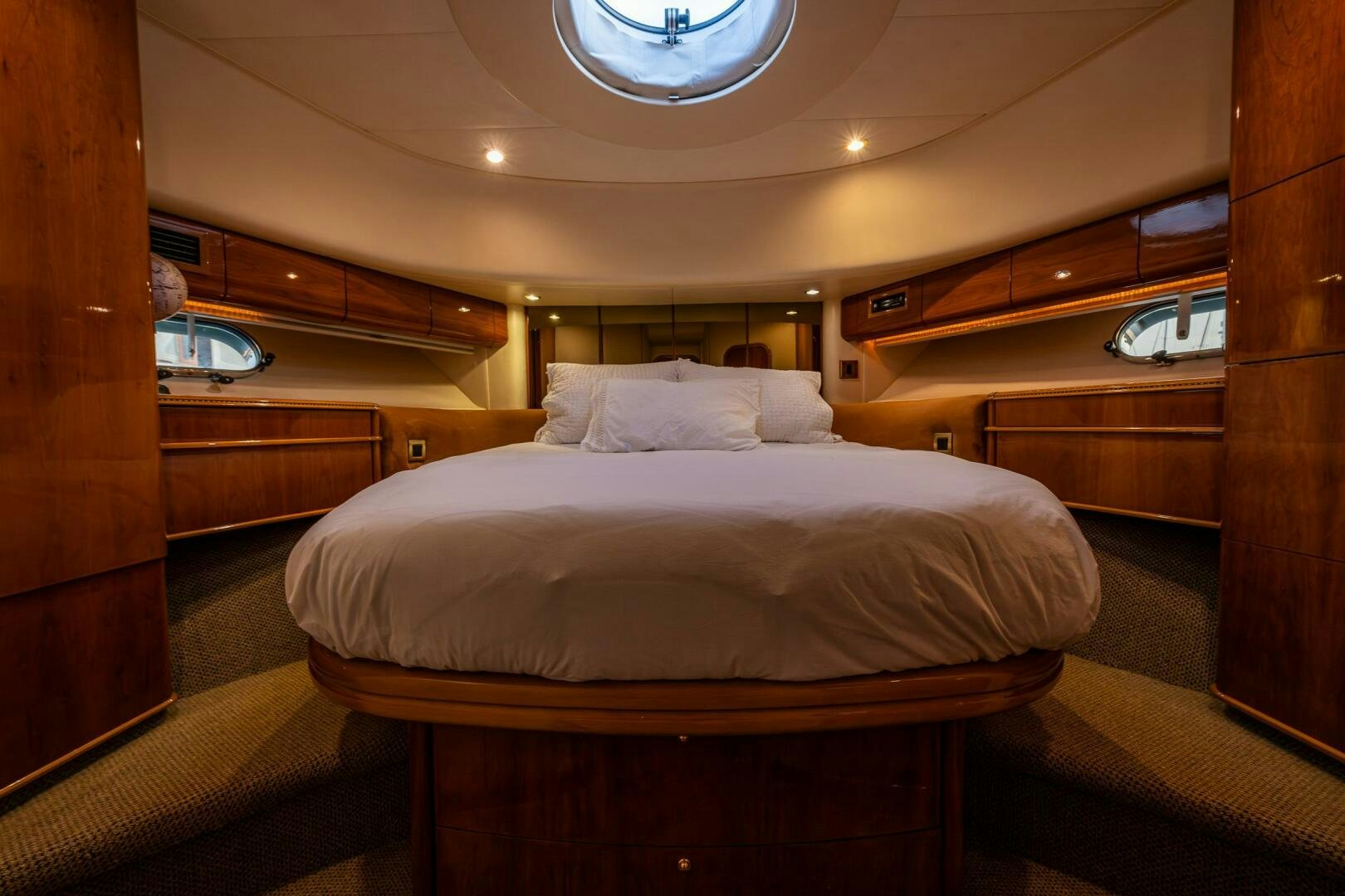 a room with a bed and a wood door aboard PEARL Yacht for Sale