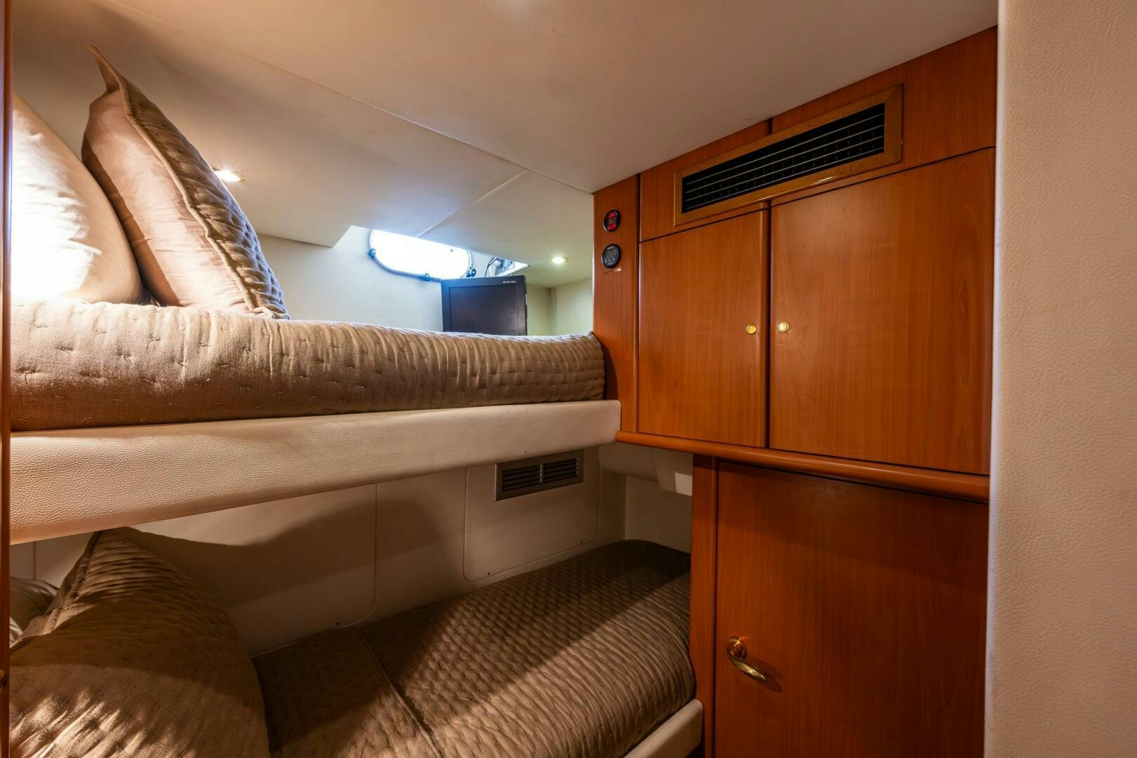 a bedroom with a bed and cabinets aboard PEARL Yacht for Sale